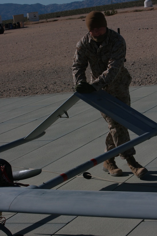 Cpl. Shane Hailey, an Unmanned Aerial Vehicle Mechanic with Unmanned Aerial Vehicle Squadron  1, pushes the RQ-7B to perform post-flight checks. Staff Sgt. Jacksby Sewell and Sgt. James Marquardsen did their yearly qualification flying their primary aircraft, which is also known as the Shadow 200.