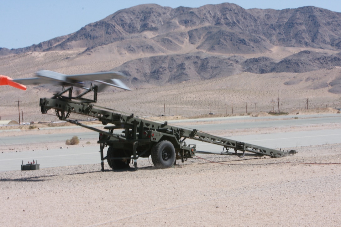 The RQ-7B, also known as the Shadow 200, shoots off the ramp as Staff Sgt. Jacksby Sewell and Sgt. James Marquardsen begin their qualification flight. Marines in an Unmanned Aerial Vehicle operator military occupational specialty must qualify with their aircraft as well as with the rifle every year.