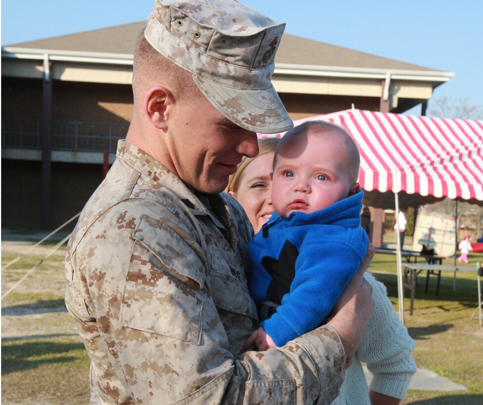 Colton Dike meets his father, Sgt. Matthew Dike of Combat Logistics Battalion-26, for the first time at a return and reunion event March 23, 2009, at Camp Lejeune, N.C. Dike returned after a seven-month deployment with the 26th Marine Expeditionary Unit.  The CLB had 10 families with newborns who met their fathers for the first time at the reunion, Monday.
