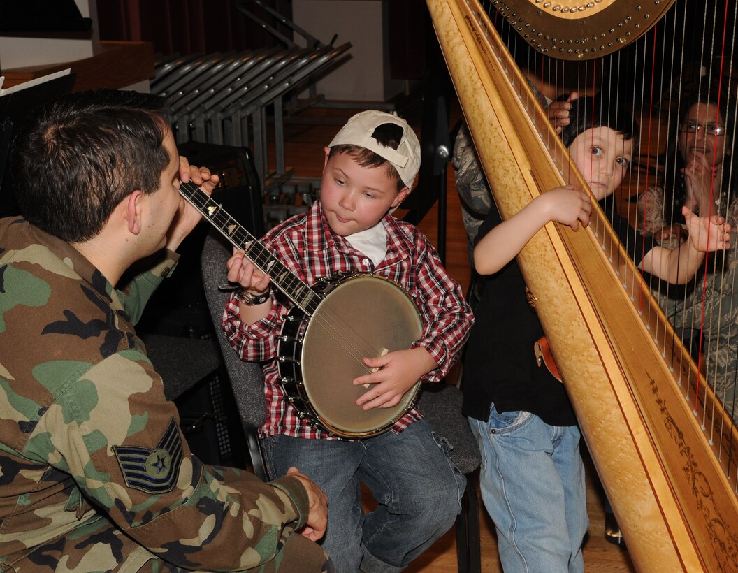 Tech. Sgt. Joe Haughton shares music tips with children from the Make-A-Wish Foundation on Bolling March 20. Children from the Make-A-Wish Foundation were invited to Bolling for the day to learn about the Air Force and the 11th Wing. The Make-A-Wish Foundation has been granting wishes to children with progressive, degenerative or malignant conditions since 1980 and has reached more than 167,000 children around the world.(U.S. Air Force photo by Senior Airman Sean Adams)