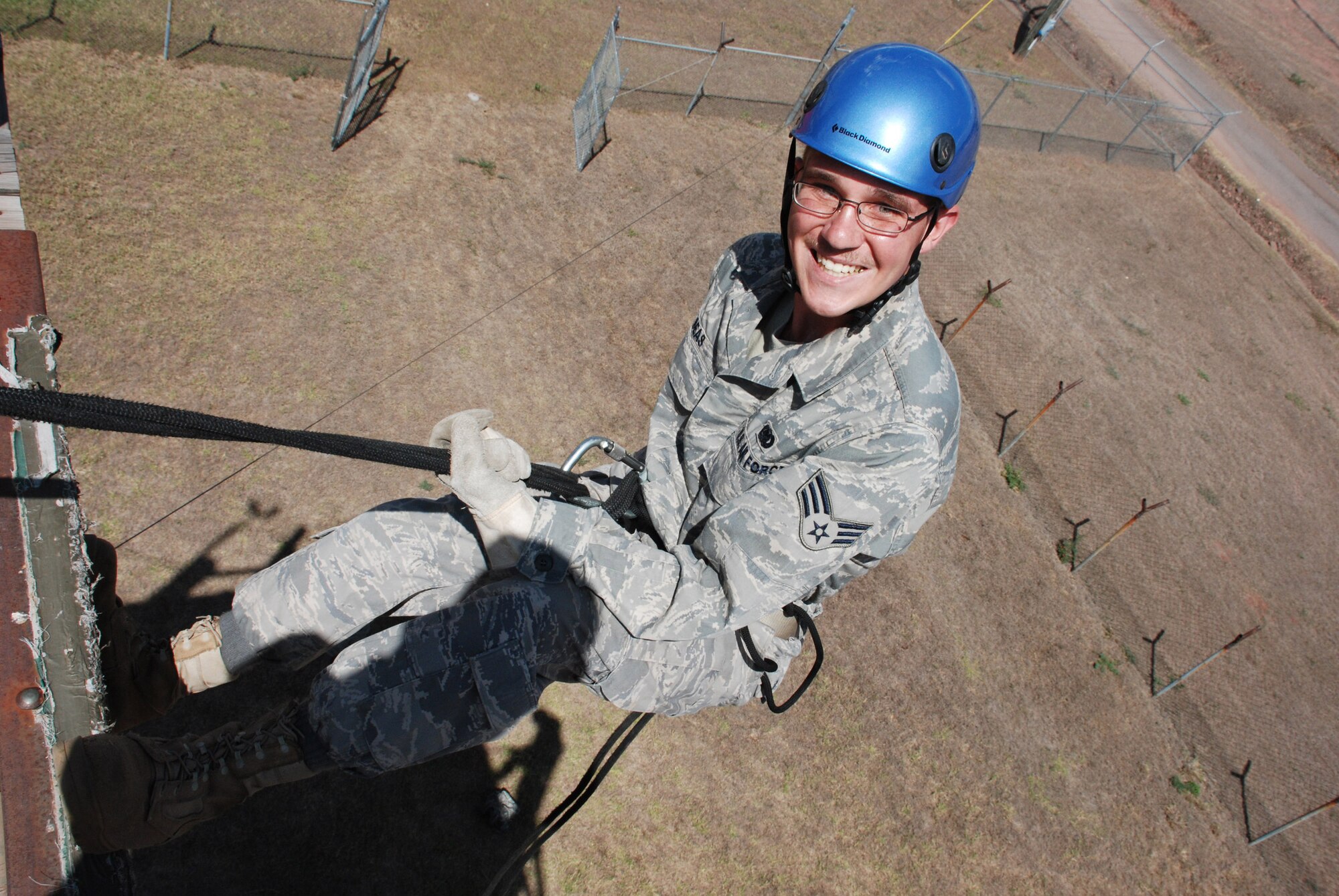 Senior Airman Daniel Seas,a fuels specialist with the 612th Air Base Squadron at Soto Cano Air Base, Honduras, rappels down a 35-foot rappel tower during joint training here March 17. Airman Seas is deployed here from Grand Forks AFB, N.D. (U.S. Air Force photo/Tech. Sgt. Mike Hammond)