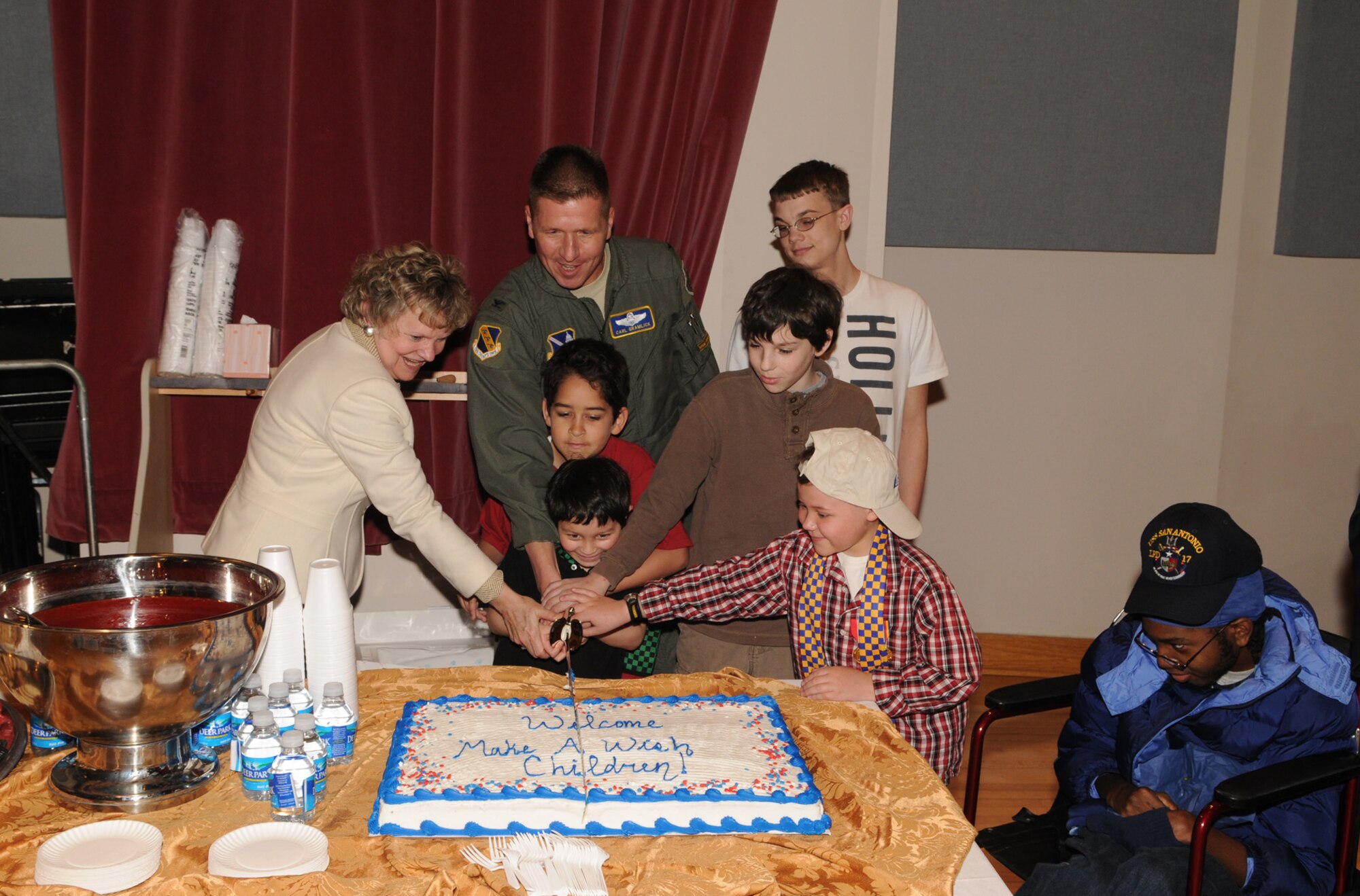 Col. Carl Gramlick cuts the cake to close out the day with the children of the Make-A-Wish Foundation March 20. The Make-A-Wish Foundation was invited to Bolling for the day to learn about the Air Force and the 11th Wing. The Make-A-Wish Foundation has been granting wishes to children with progressive, degenerative or malignant conditions since 1980 and has reached more than 167,000 children around the world.(U.S. Air Force photo by Senior Airman Sean Adams)