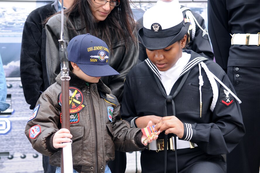 A Make-A-Wish child receives special recognition from the first female member of the Navy Ceremonial Guard March 20 on Bolling. The Make-A-Wish Foundation has been granting wishes to children with progressive, degenerative or malignant conditions since 1980 and has reached more than 167,000 children around the world. (U.S. Air Force photo by Senior Airman Sean Adams)