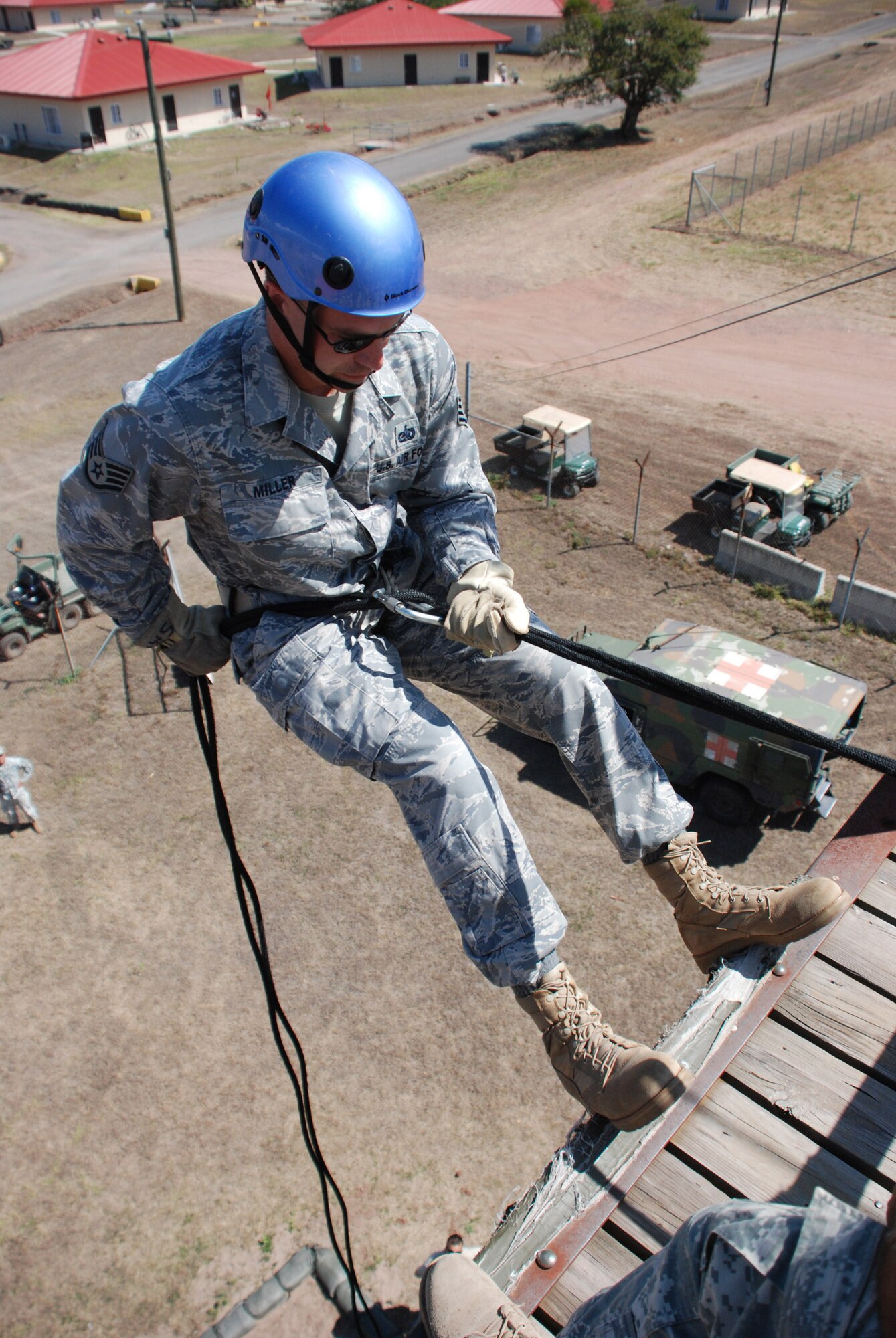 Staff Sgt. David Miller, a fuels specialist with the 612th Air Base Squadron at Soto Cano Air Base, Honduras, prepares to rappel down a 35-foot rappel tower during joint training here March 17. Sergeant Miller is deployed to Soto Cano from Grand Forks AFB, N.D. (U.S. Air Force photo/Tech. Sgt. Mike Hammond)