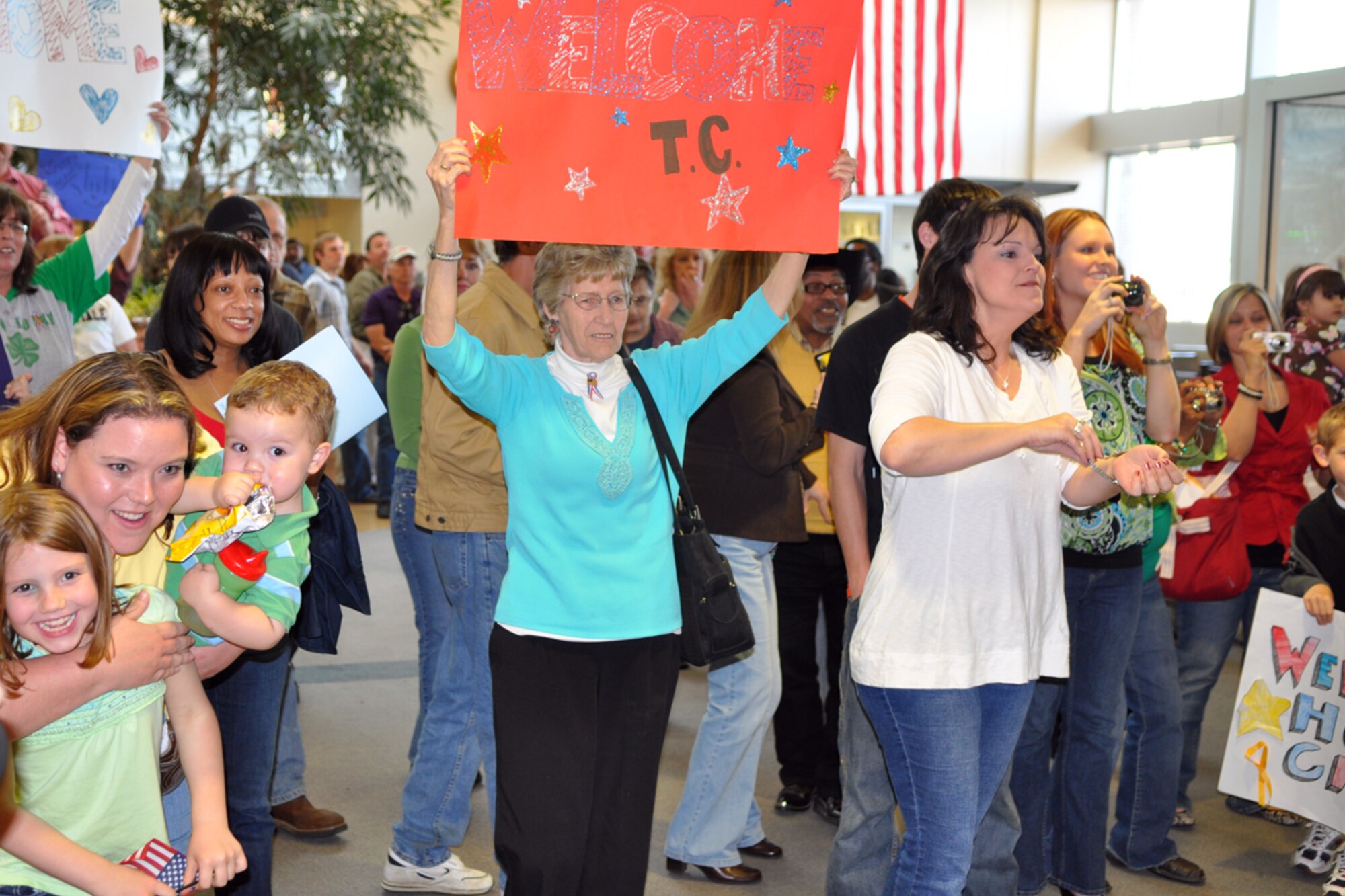 Family and friends show their excitement as Airmen from the 917th Civil Engineer Squadron, Barksdale Air Force Base, La., arrive at the Shreveport Regional Airport March 17, 2009. The Airmen, who have been deployed to Kirkuk Regional Air Base, Iraq, for the last six months were all smiles as the waded in the crowd of approximately 120 well wishers who showed at the airport to welcome home the local heroes.  (US Air Force photo/Tech. Sgt. Jeff Walston)
