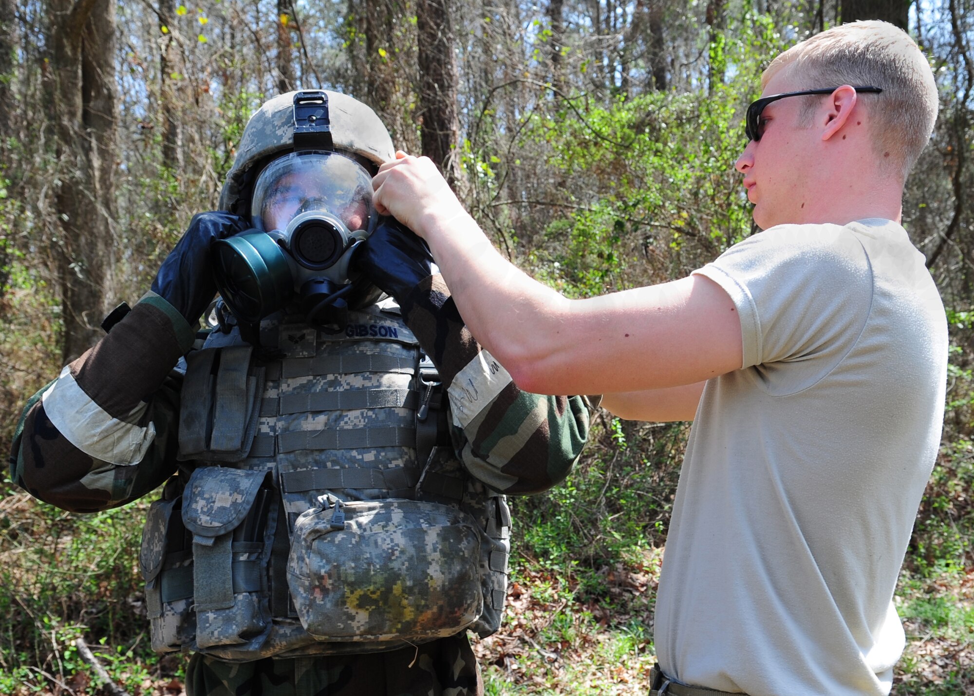Senior Airman Ross Turner (right) helps Senior Airman Cooper Gibson suit up in chemical warfare gear during an explosive ordinance disposal training exercise at Seymour Johnson Air Force Base, N.C., March 19, 2009. The exercise evaluates the Airmen's ability to locate, identify and dispose a chemical weapon. Both Airmen are explosive ordnance disposal specialists from the 4th Civil Engineer Squadron. (U.S. Air Force Photo by Airman 1st Class Rae Perry)