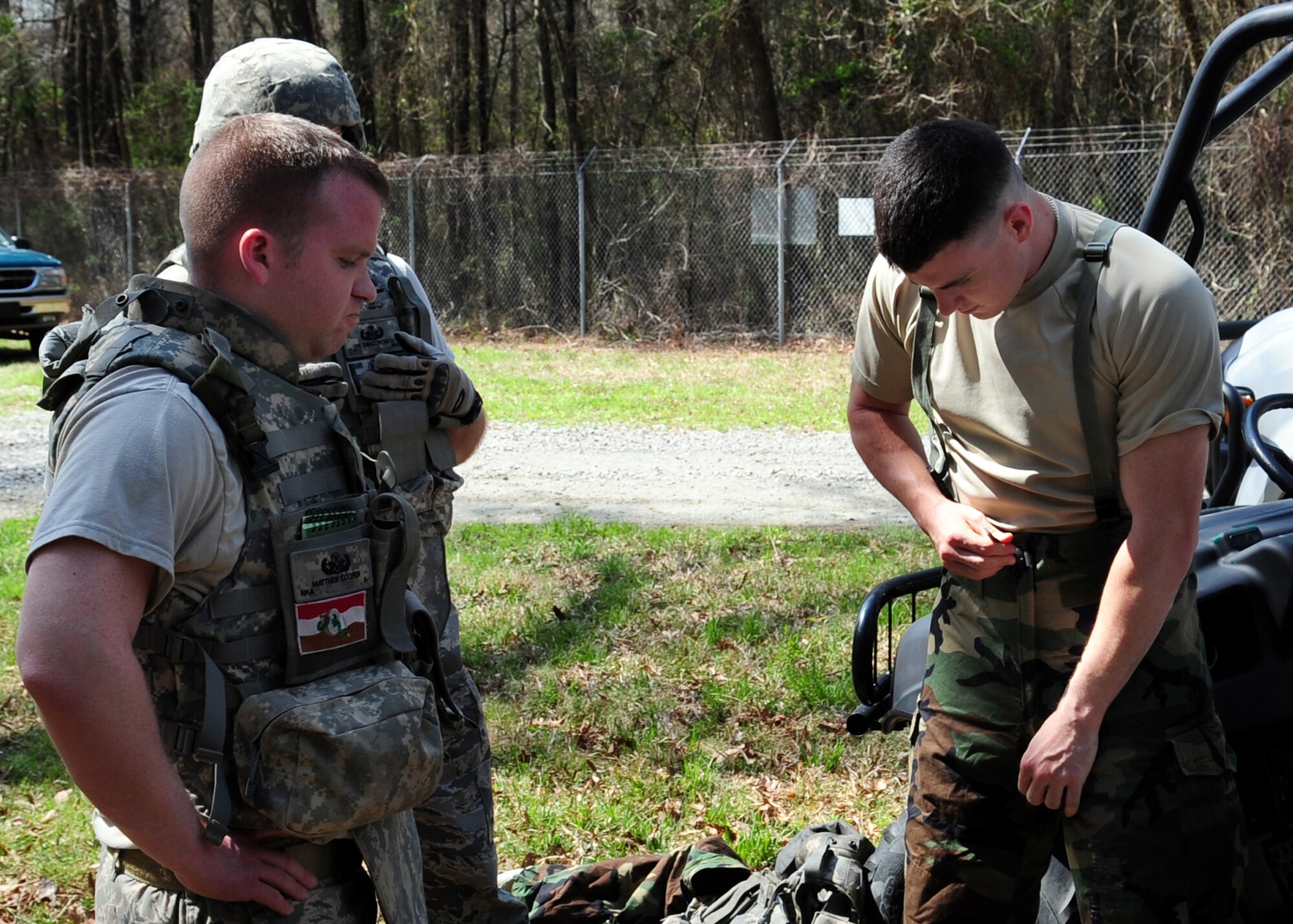 Staff Sgt. Matthew Cooper (left) supervises Senior Airman Cooper Gibson as he dons his chemical warfare gear for a training exercise on Seymour Johnson Air Force Base, N.C., March 19, 2009. As the team leader for the exercise, Sergeant Cooper ensures his team locates, identifies and disposes of a chemical hazard in a safe and timely manner. Both Airmen are explosive ordnance disposal specialists with the 4th Civil Engineer Squadron. (U.S. Air Force Photo by Airman 1st Class Rae Perry)