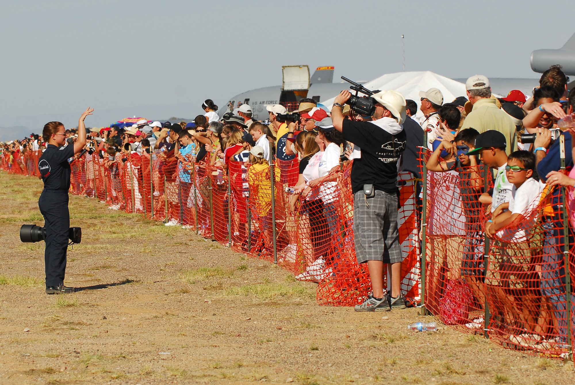 Staff Sgt. Kristi Machado, the Public Affairs photographer with the U.S. Air Force Thunderbird Aerial Demonstration Team, waves to spectators during the Thunderbird performance at the 2009 Luke Thunder in the Desert Air Show, March 21. (U.S. Air Force photo/Airman 1st Class Tracie Forte)