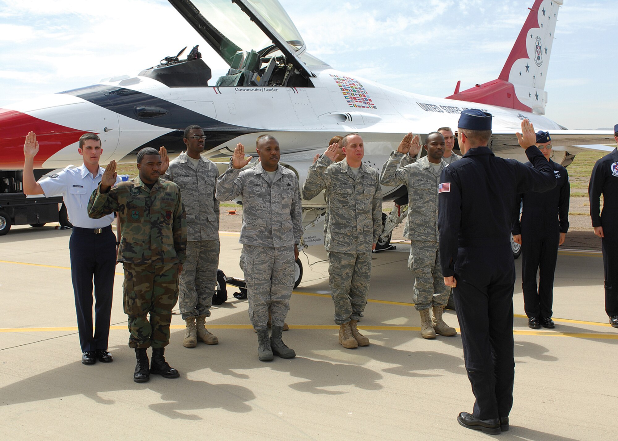 Nine Luke members took the oath to support and defend the constitution of the United States during the re-enlistment ceremony in front of the Air Force's Air Demonstration squadron, Mar. 19. Lt Col Greg Thomas, the Thunderbirds commander administered the oath to the airmen. (U.S. Air Force photo/Tech Sgt. Raheem Moore)