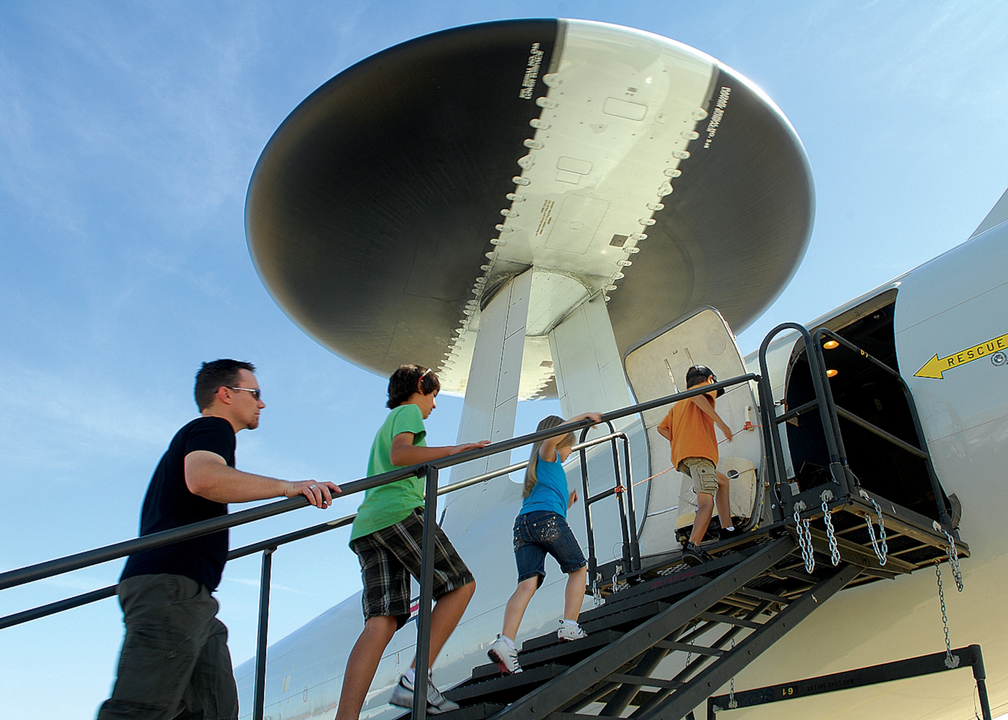 Spectators eagerly make their way up the stairs of an E-3 Sentry (AWACS) aircraft to get a view inside the airborne warning and control system during the Thunder in the Desert Air Show and Open House. (U.S. Air Force photo/Tech. Sgt. Raheem Moore)