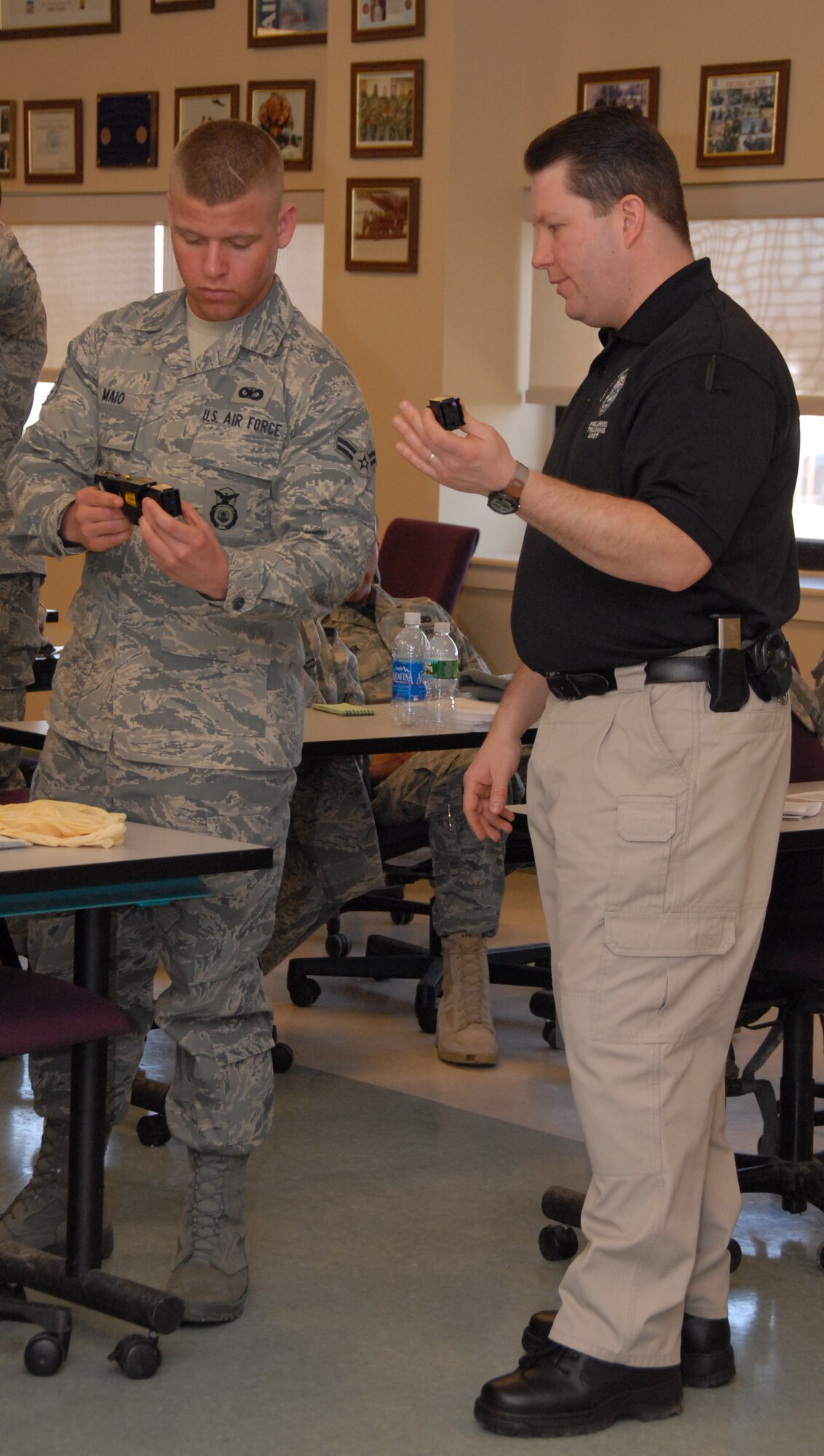 Officer Tom Licata, Niagara Falls Police Department Firearms Instructor, schools Airman 1st Class Michael Maio on the proper use of the X26 Taser. During a daylong class, 107 AW Security Force Members learned the techniques necessary to safely immobilize an evil doer using an electronic control device aka Taser.    