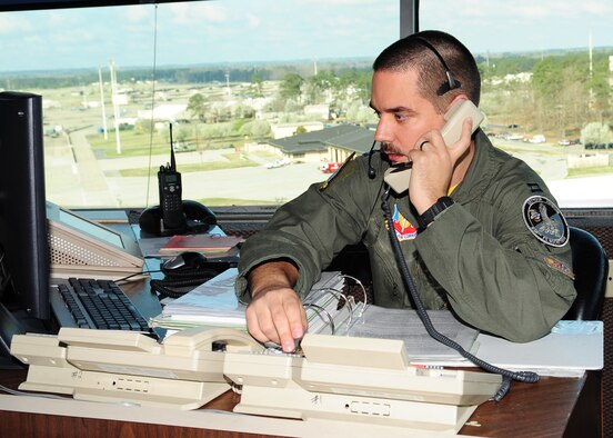 Capt. Nathan White, 336th Fighter Squadron, is currently the supervisor of flying in the air traffic control tower on Seymour Johnson Air Force Base, N.C., March 20, 2009. While aircraft are flying, an aviator from one of the 4th Fighter Wing's four fighter squadrons serves as a liaison between tower personnel and the fighter squadrons. (U.S. Air Force Photo by Airman 1st Class Rae Perry)