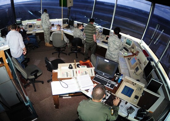 Airmen with the 4th Operations Support Squadron's Airfield Operations Flight manage the air space from the air traffic control tower on Seymour Johnson Air Force Base, N.C., March 20, 2009. The role of the Airmen in the tower is to help the airfield run smoothly. Ground control, supervisor of flying, and watch supervisor are just a few of the jobs that Airmen accomplish while working in the tower. (U.S. Air Force Photo by Airman 1st Class Rae Perry)