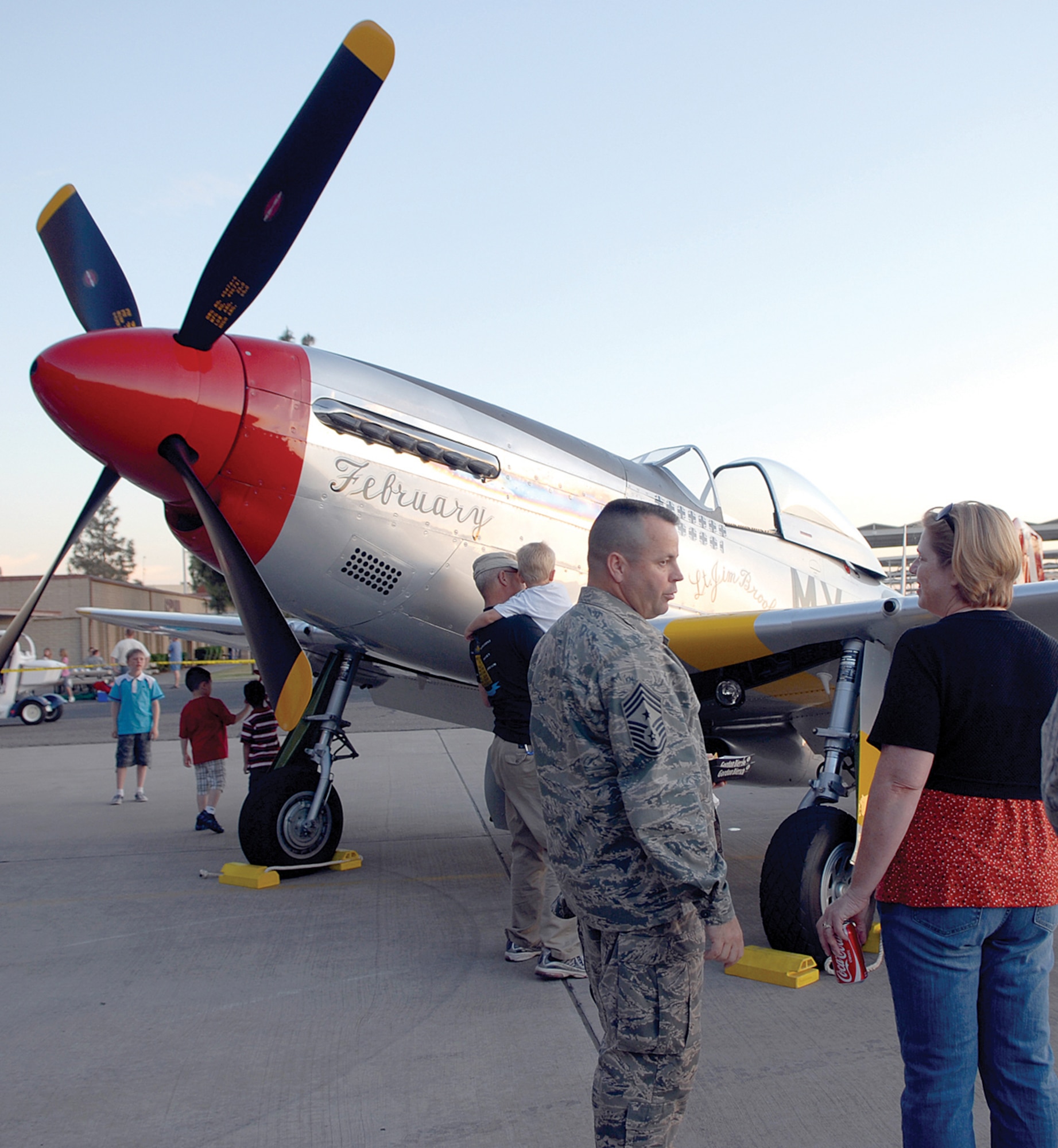 Chief Master Sgt. Randall Raper, 56th Fighter Wing command chief, and his wife, Michelle Helms-Raper, stand before a P-51D model Mustang during the Luke Days 2009 Kick Off Hangar Party held at Hangar 431 March 20. The "D" model Mustang was flown by retired Maj. Jim Brooks, an honorary guest at the Hangar Party.  (U.S. Air Force photo/Airman 1st Class Ronifel Yasay)