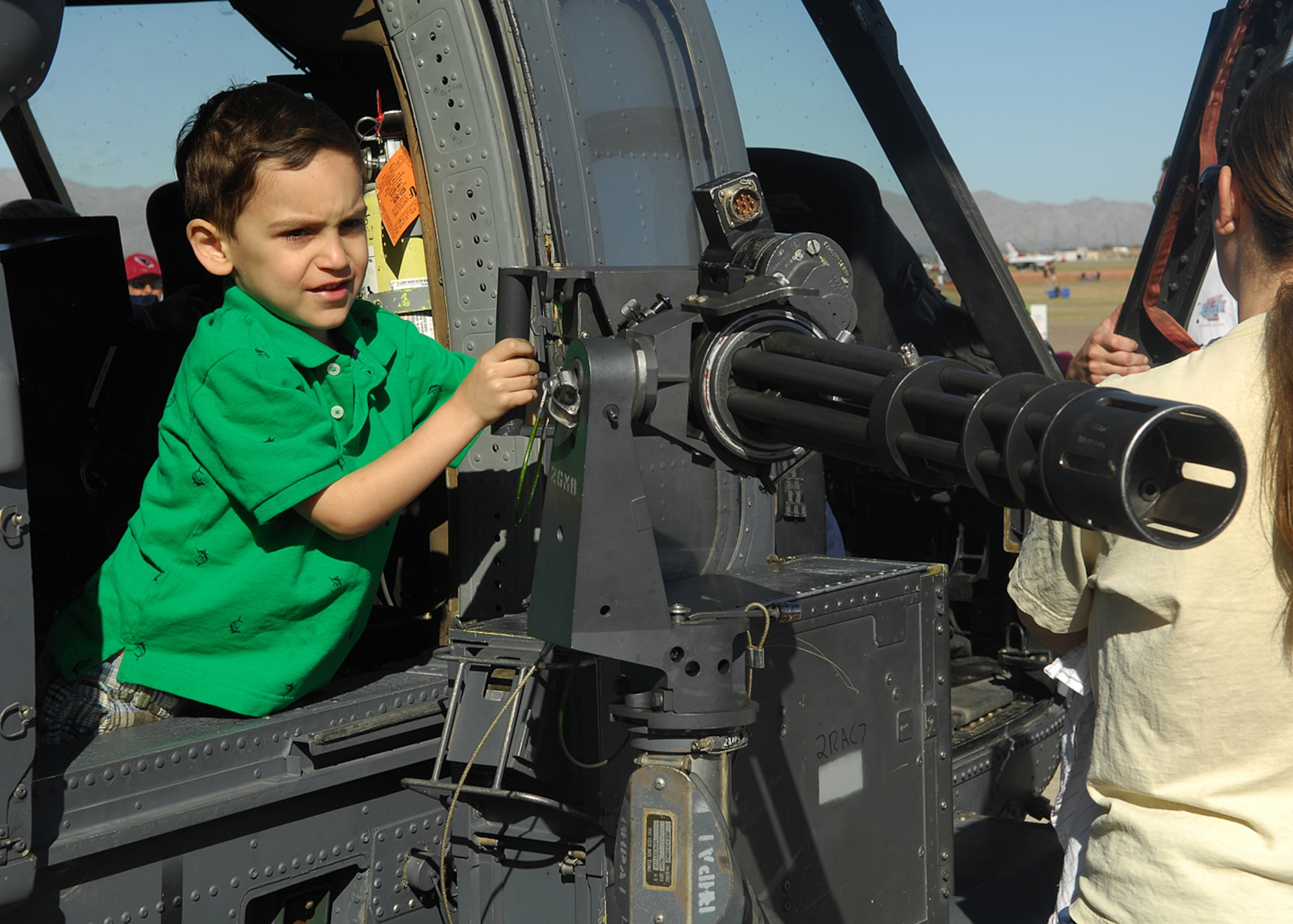 Diego Zayas-Marianos 5, sets his sights before aiming the .50 caliber machine gun on the HH-60G Pave Hawk helicopter during the 2009 Thunder in the Desert Air Show and Open House. (U.S. Air Force photo/Tech. Sgt. Raheem Moore)   