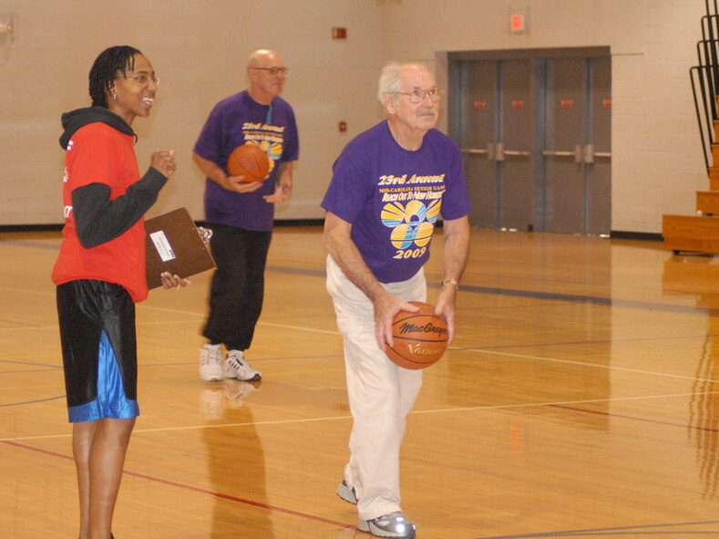 A participant of the Mid-Carolina Senior Games attempts to hit a 3-point shot at the Pope Fitness Center March 23. More than 500 seniors from Sampson, Harnett and Cumberland county participated in this year’s games. Events included softball, discus and football throws, shot-put, fishing reel casting, long jump and basketball. Pope members came out in full force to volunteer and help with this event. (U.S. Air Force Photo by Tech. Sgt. Todd Wivell)