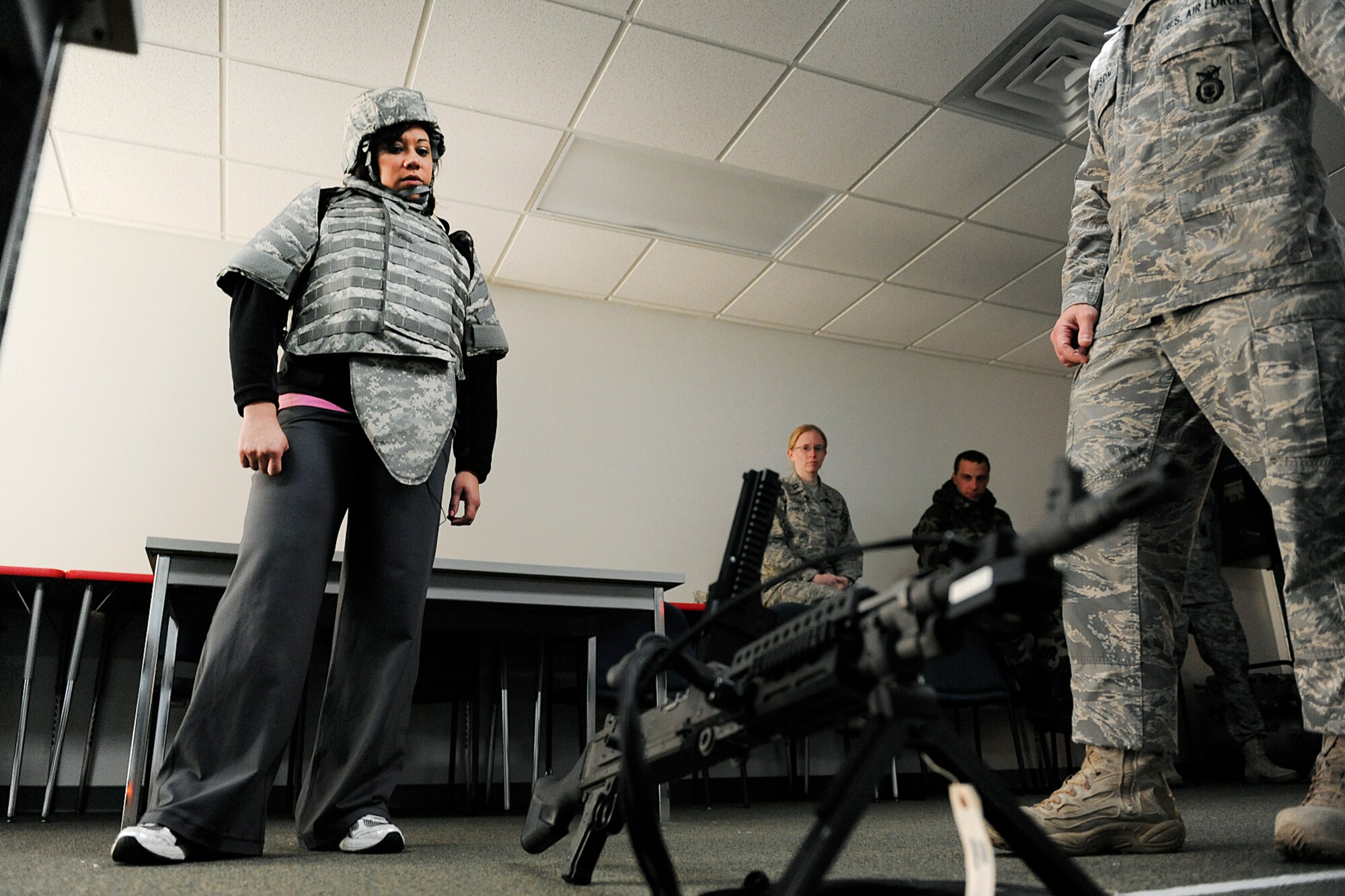LANGLEY AIR FORCE BASE, Va. -- Master Sgt. Richard Thompson, 1st Security Forces Squadron combat arms non-commissioned officer in charge, explains the M-240 bravo machine gun to Mrs. Bianca Martinez, WTKR Channel 3 broadcaster, here March 23.  Mrs. Martinez started a series entitled "Do My Military Job," which allows her to learn about various jobs within each branch of the military.  (U.S. Air Force photo/Senior Airman Vernon Young)