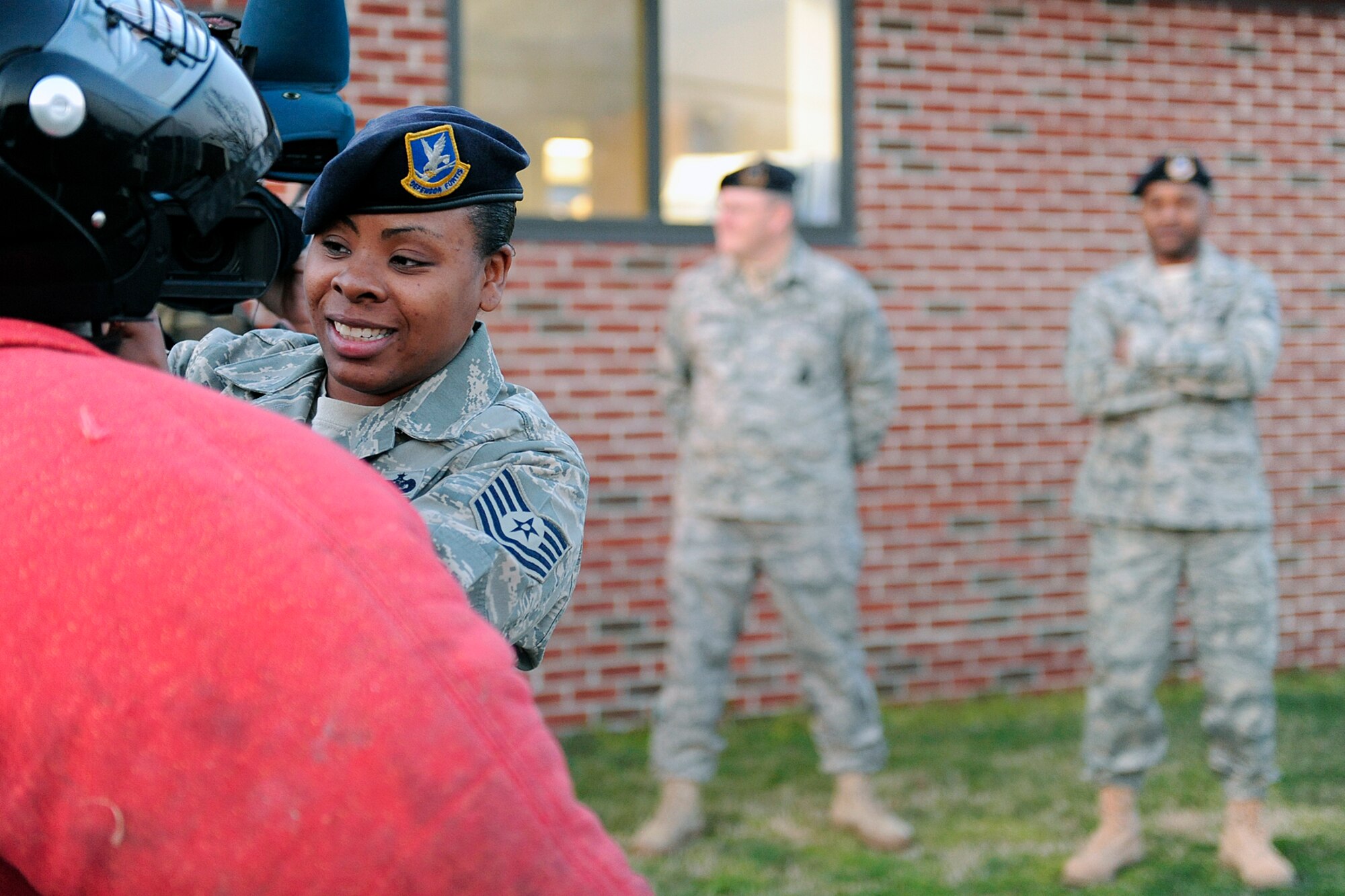 LANGLEY AIR FORCE BASE, Va. -- Tech. Sgt. Naomi Copeland, 1st Security Forces Squadron kennel master, adjusts the bite suit headgear for Mrs. Bianca Martinez, WTKR Channel 3 broadcaster, before educating her on a fleeing victim scenario, here March 23.  Mrs. Martinez started a series entitled "Do My Military Job," which allows her to learn about various jobs within each branch of the military.  (U.S. Air Force photo/Senior Airman Vernon Young)