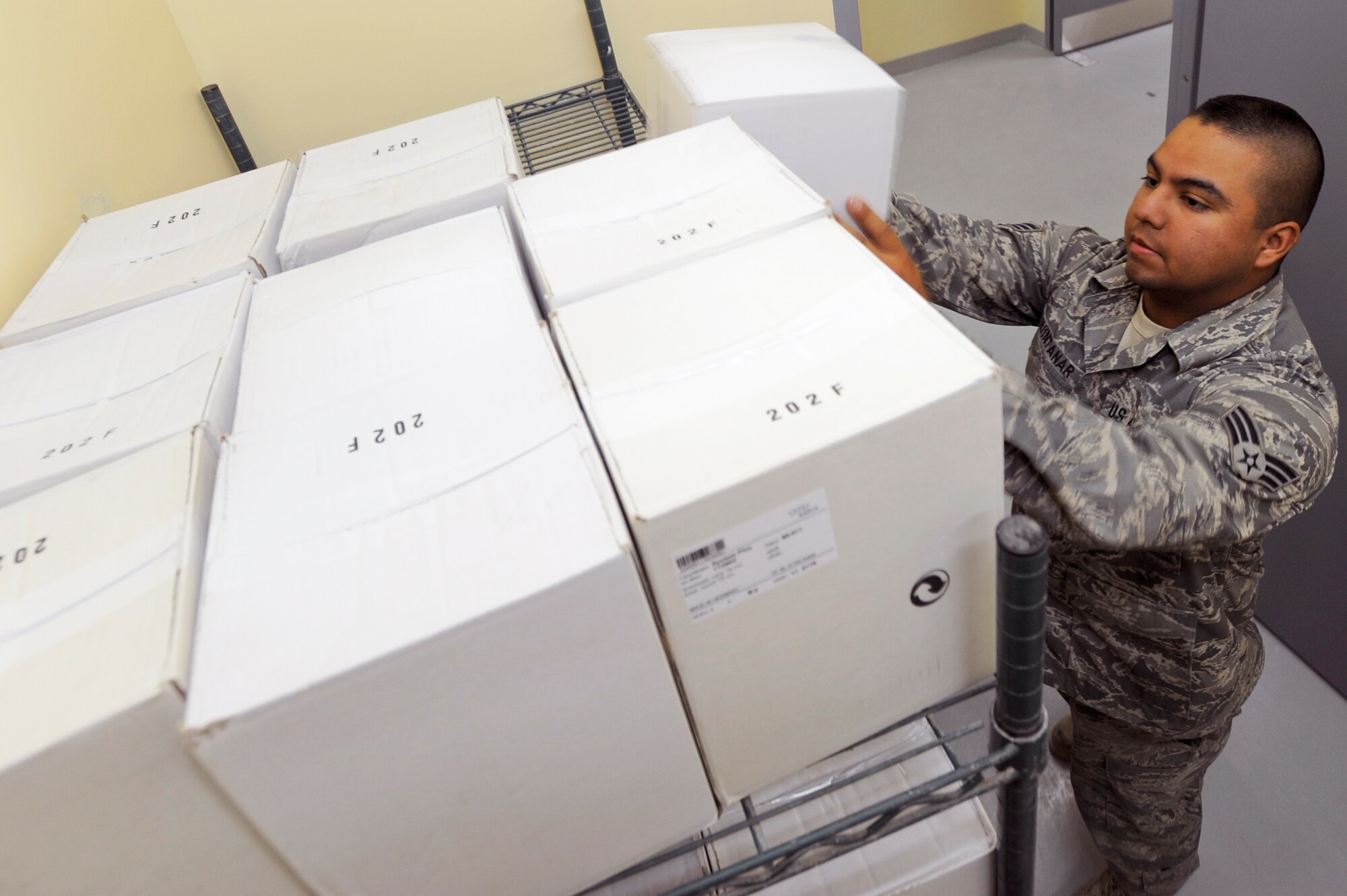 Senior Airman Ricardo Quintanar stocks the new Coalition Compound Dining Facility with supplies March 23 at an air base in Southwest Asia. Airman Quintanar is a services journeyman with the 379th Expeditionary Force Support Squadron.(U.S. Air Force photo/Staff Sgt. Joshua Garcia)