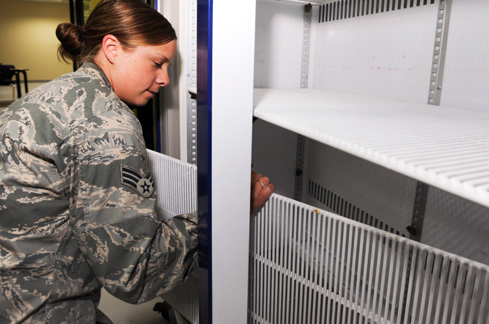 Senior Airman Mandy Woodard sets up a beverage refrigerator in the new Coalition Compound Dining Facility in preparation for the grand opening March 23 at an air base in Southwest Asia. Airman Woodard is moving equipment to the new dining facility while still having to complete their regular duties at their own work place. Airman Woodard is a services journeyman with the 379th Expeditionary Force Support Squadron. She hails from Stark, N.H., and is deployed from Pease Air National Guard Base, N.H. (U.S. Air Force photo/Staff Sgt. Joshua Garcia) 
