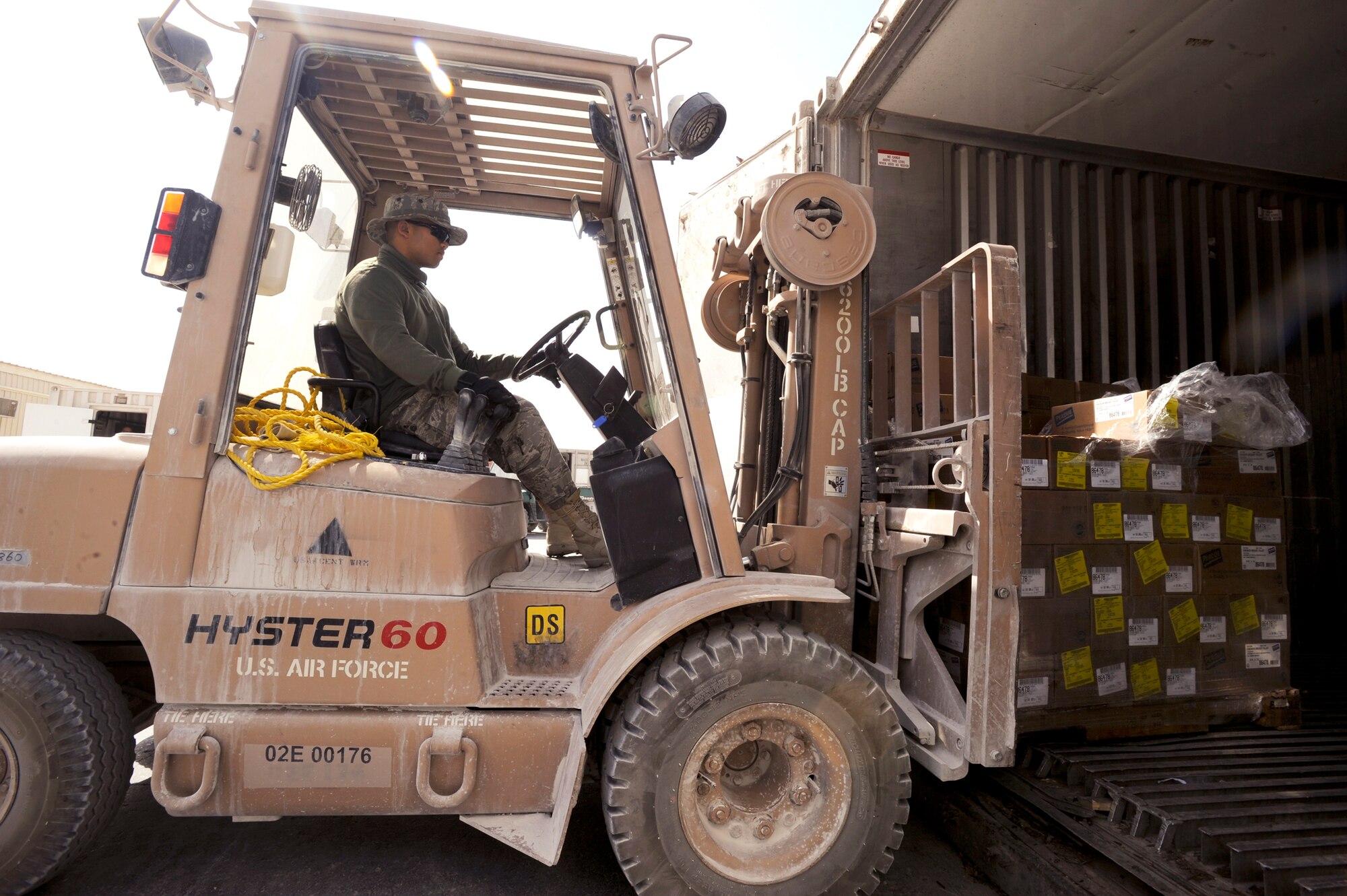Staff Sgt. Samneng Seng restocks a food storage container with supplies March 23 at an air base in Southwest Asia. Sergeant Seng is with the 379th Expeditionary Force Support Squadron and is the store room manager for the Independence Dining Facility where he ensures all the food on the menu for the following day is ordered and stocked properly. Sergeant Seng is a native of Lynn, Mass., and is deployed from Pease Air National Guard Base, N.H. (U.S. Air Force photo/Staff Sgt. Joshua Garcia) 
