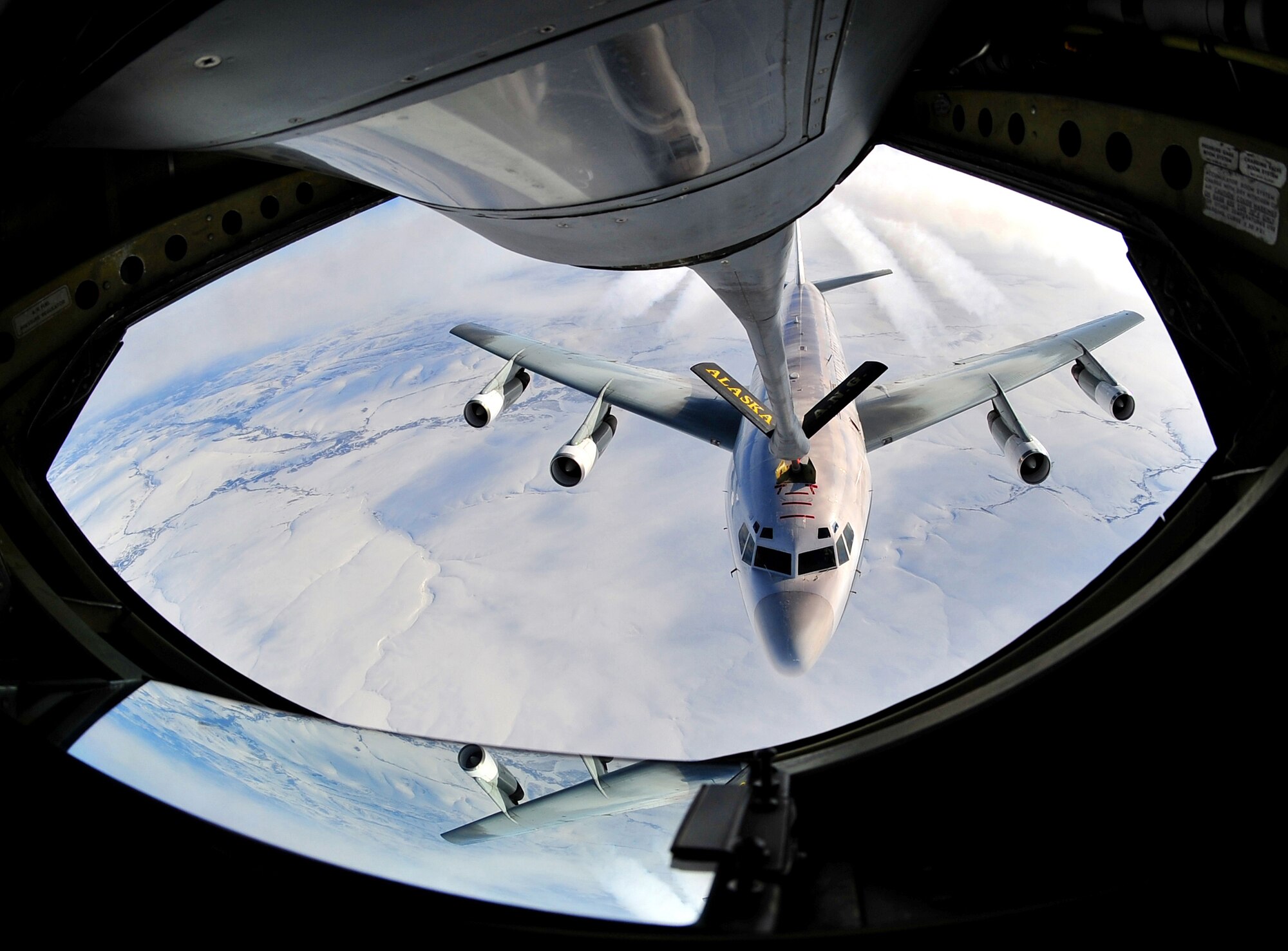 A military aircraft holds steady while being refueled March 22, 2008, Eielson Air Force Base, Alaska. The mission of the 168th Air Refueling Wing is to train Alaska's Guardsmen who provide a constant Air Force capability of global reach and vigilance, by means of the KC-135 aircraft and early warning space system, and stand ready to protect American resources and Alaskan communities. (U.S. Air Force photo/Airman 1st Class Willard E. Grande II)