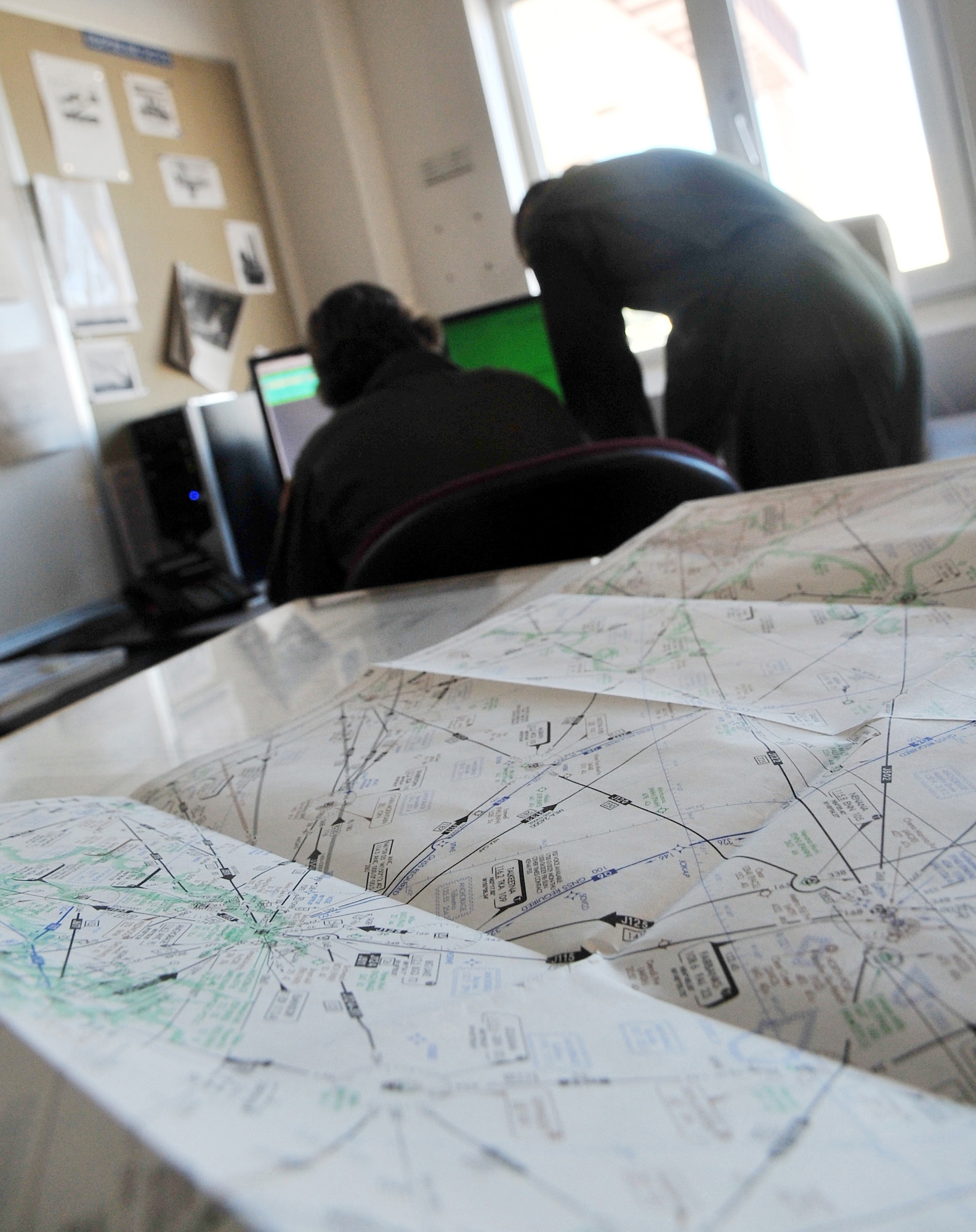 Two crewmembers from the 168th Air Refueling Wing review their flight plans March 22, 2008, Eielson Air Force Base, Alaska. The mission of the 168th Air Refueling Wing is to train Alaska's Guardsmen who provide a constant Air Force capability of global reach and vigilance, by means of the KC-135 aircraft and early warning space system, and stand ready to protect American resources and Alaskan communities. (U.S. Air Force photo/Airman 1st Class Willard E. Grande II)