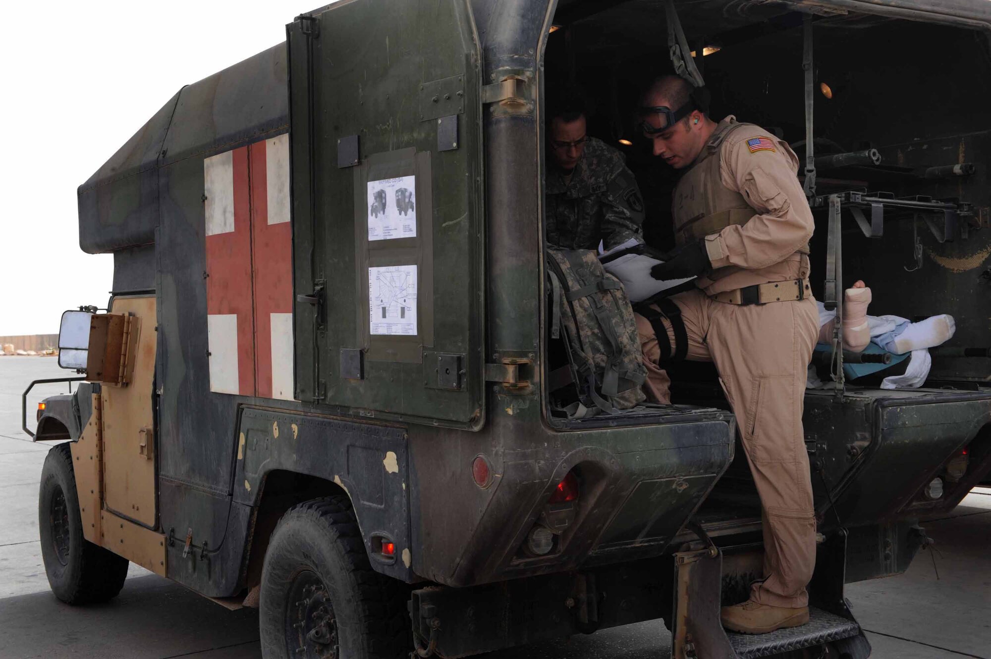 At Camp Speicher, Iraq, Tech. Sgt. Daniel Wood, an aeromedical technician with the 332nd Expeditionary Operations Support Squadron Expeditionary Aeromedical Evacuation Flight, checks paperwork before loading patients on a 777th Expeditionary Airlift Squadron C-130 Hercules. (U.S. Air Force photo/Senior Airman Elizabeth Rissmiller)