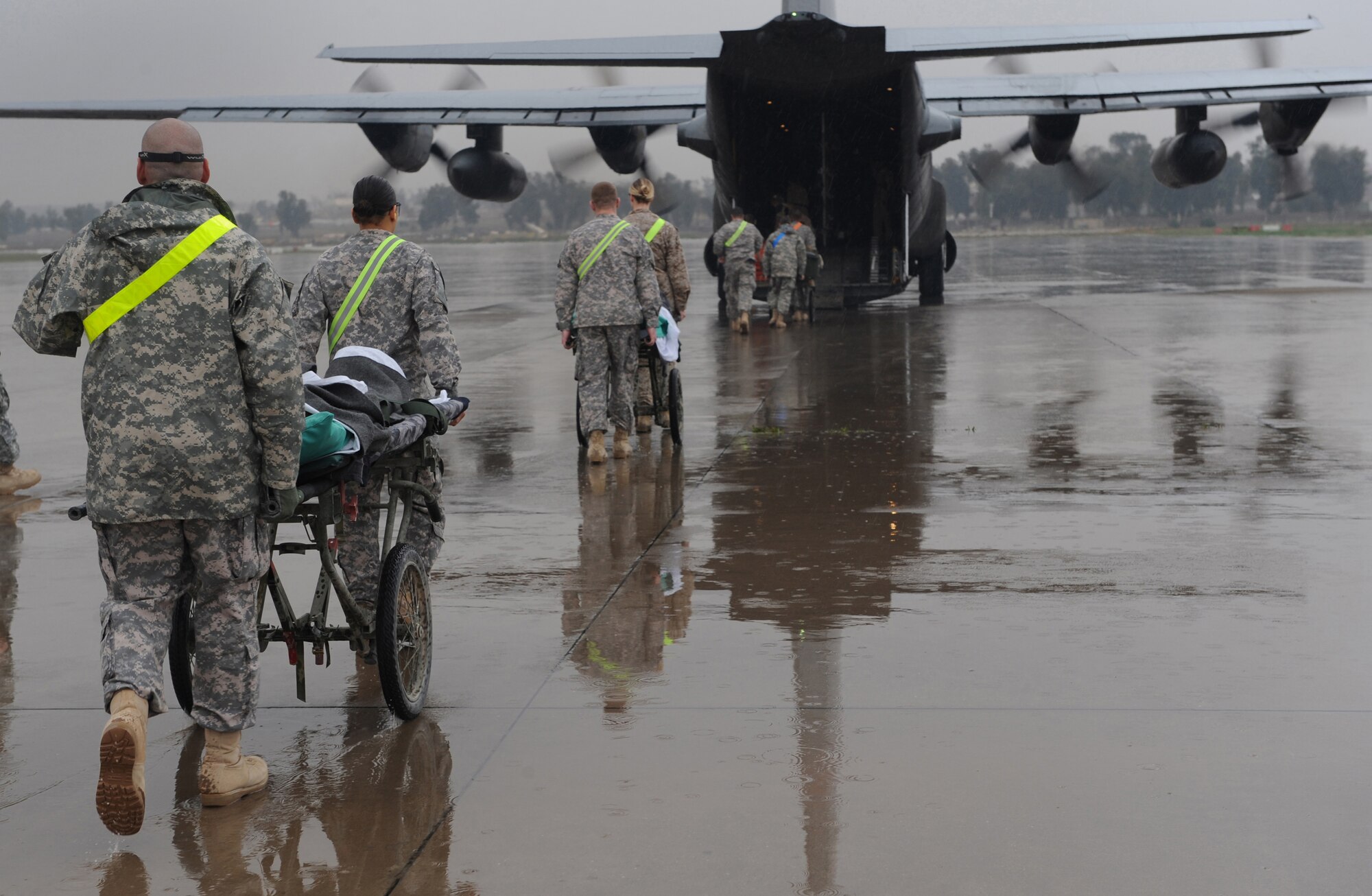 In Mosul, Iraq, Soldiers walk patients on litters to a 777th Expeditionary Airlift Squadron C-130 Hercules for transport on an aeromedical evacuation mission to Joint Base Balad, Iraq, Feb. 27, 2009. (U.S. Air Force photo/Senior Airman Elizabeth Rissmiller)