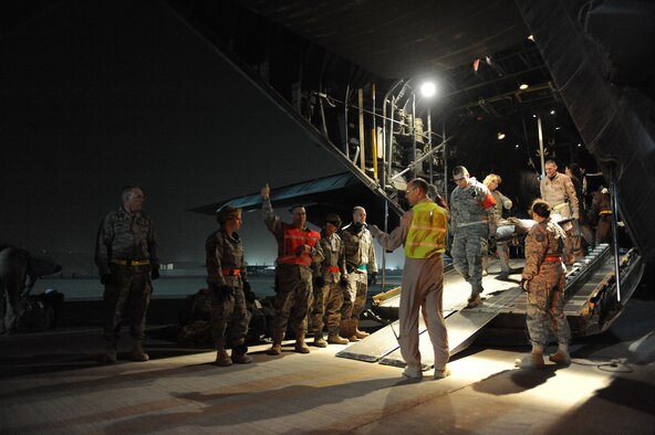 Airmen from the 332nd Expeditionary Operations Support Squadron's Expeditionary Aeromedical Evacuation Flight and the 332nd Expeditionary Medical Group Contingency Aeromedical Staging Facility along with volunteers wait with stretchers and buses to off-load patients at Joint Base Balad, Iraq, after an aeromedical evacuation mission Feb. 27, 2009. The 332nd EAEF transports servicemembers wounded, injured or sick from remote locations to a higher level of medical care. (U.S. Air Force photo/Senior Airman Elizabeth Rissmiller)