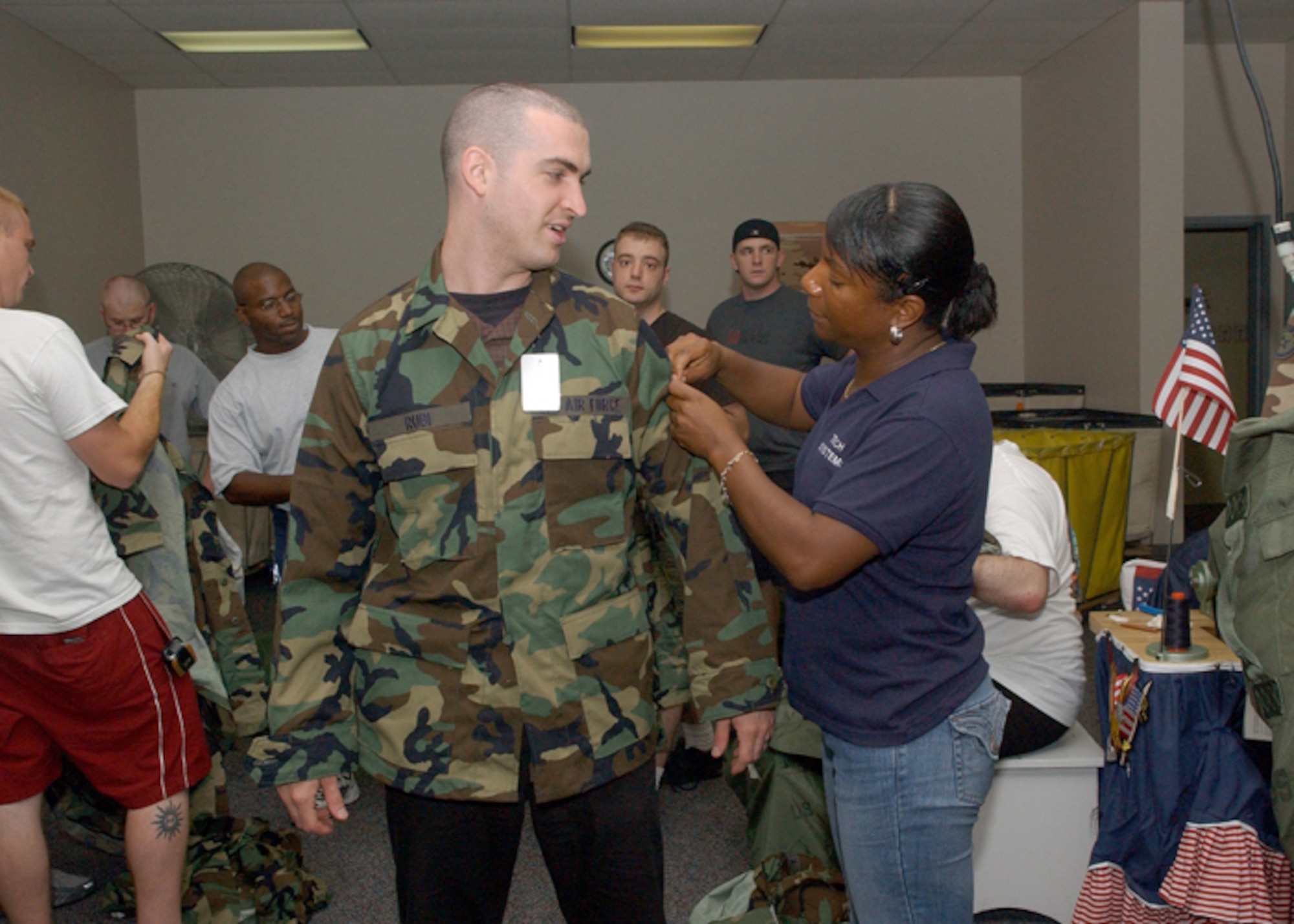 Capt. Darren Rubi gets his uniform quality checked by Karen Walker at clothing issue during the Push-Pull 2007 exercise at Lackland Air Force Base, Texas. Push-Pull 2009 is scheduled to take place April 6 to 10 at Lackland AFB and will include 150 regular Air Force retirees.  These biennial exercises are designed to exercise and evaluate the Air Force's mobilization processes and crisis-action procedures. (U.S. Air Force photo/Alan Boedeker)
