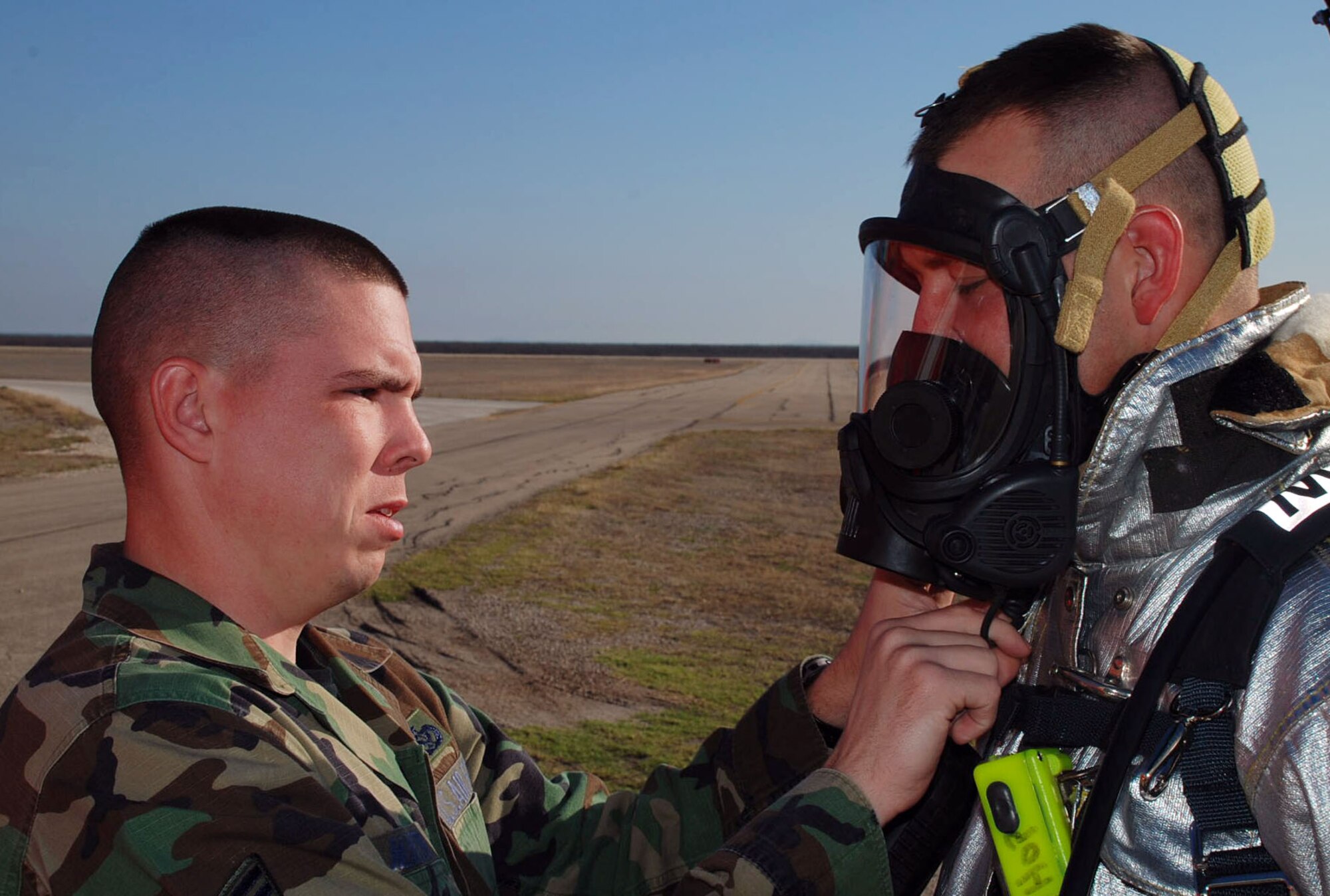 SPOFFORD AUXILIARY FIELD, Texas -- Senior Airman Ben Hopper, 47th Installation Support Squadron fire department, has his firefighting equipment checked by Staff Sgt. Brandon Martin, 47th Installation Support Squadron fire department, while on duty at Spofford Auxiliary Field recently. (U.S. Air Force photo by Tech. Sgt. Charlie Miller)