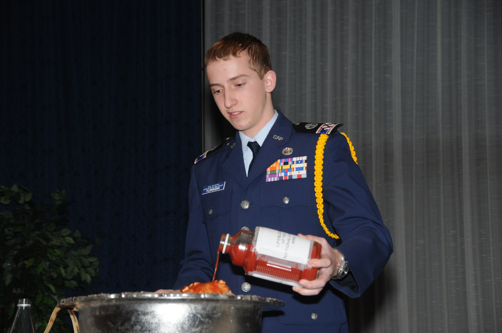 Cadet Lt. Col. James Flanagan adds an unidentified liquid to the grog bowl during the CAP’s National Capital Wing’s annual awards banquet and change of command ceremony March 14 at the Bolling Club. (Photo by C. Todd Lopez)