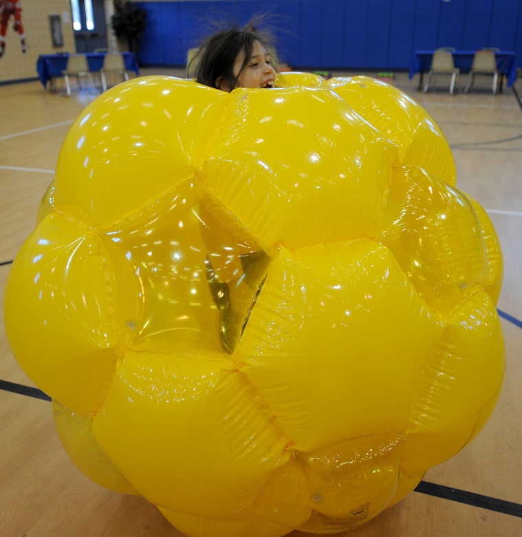 LANGLEY AIR FORCE BASE, Va.-- Shannon, daughter of Lt. Col. Joseph Henderson, Air Combat Command Operations Directorate, shows off her static hair as she enjoys a blow-up ball during Spring Fling events at the Shellbank Youth Center March 23. The Spring Fling was a day of fun and games for the families of deployed Airmen. (U.S. Air Force photo/Airman Rebecca Montez)