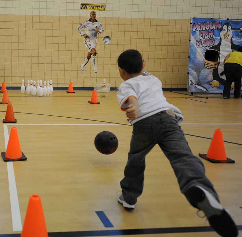 LANGLEY AIR FORCE BASE, Va.-- Antionio, son of Staff Sgt. David Riddick, 1st Security Forces Squadron, tries out his bowling skills during Spring Fling events at the Shellbank Youth Center March 23. The Spring Fling was a day of fun and games for the families of deployed Airmen. (U.S. Air Force photo/Airman Rebecca Montez)