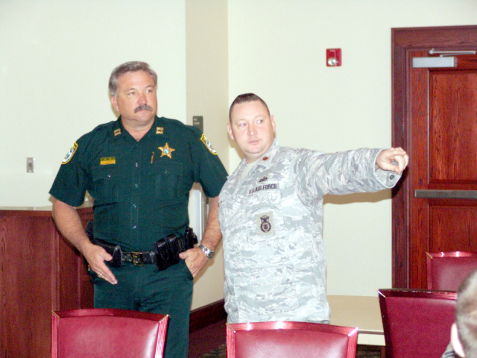 EGLIN AIR FORCE BASE, Fla. - Maj. Scott Foley, 96th Security Forces commander, speaks with a law enforcement officer at the first quarterly law enforcement luncheon March 20 organized by the 96th Security Forces Squadron and the Air Force Office of Special Investigations. The luncheon is scheduled to be a quarterly event to foster teamwork among area law agencies. (U.S. Air Force photo/Noel Getlin)
