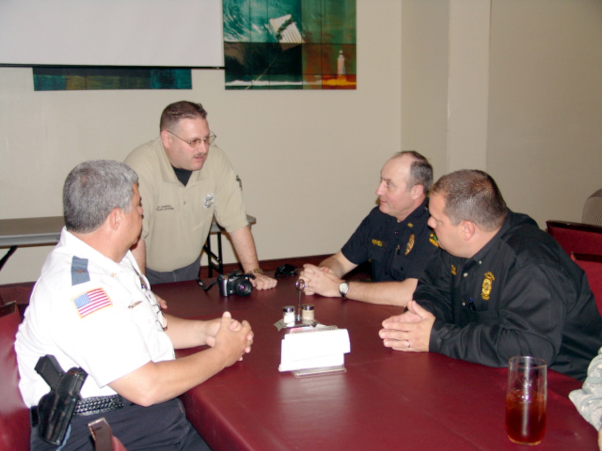 EGLIN AIR FORCE BASE, Fla. - Law enforcement officials from three agencies talk after the first quarterly law enforcement luncheon organized by the 96th Security Forces Squadron and the Air Force Office of Special Investigations. The luncheon is scheduled to be a quarterly event to foster teamwork among area law agencies. (U.S. Air Force photo/Noel Getlin)
