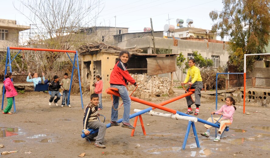 Local Turkish children play on the newly renovated park that was completed Wednesday, Feb. 25, 2009.  The two-month project was a huge success due to the efforts of Air National Guardsmen who were in Turkey on temporary duty supporting air operations for Central Command. The lot started life as a neglected lot covered in trash and rainwater and now sports new playground equipment that will provide enjoyment for the local children for years to come. (U.S. Air Force photo/Airman 1st Class Amber Russell)