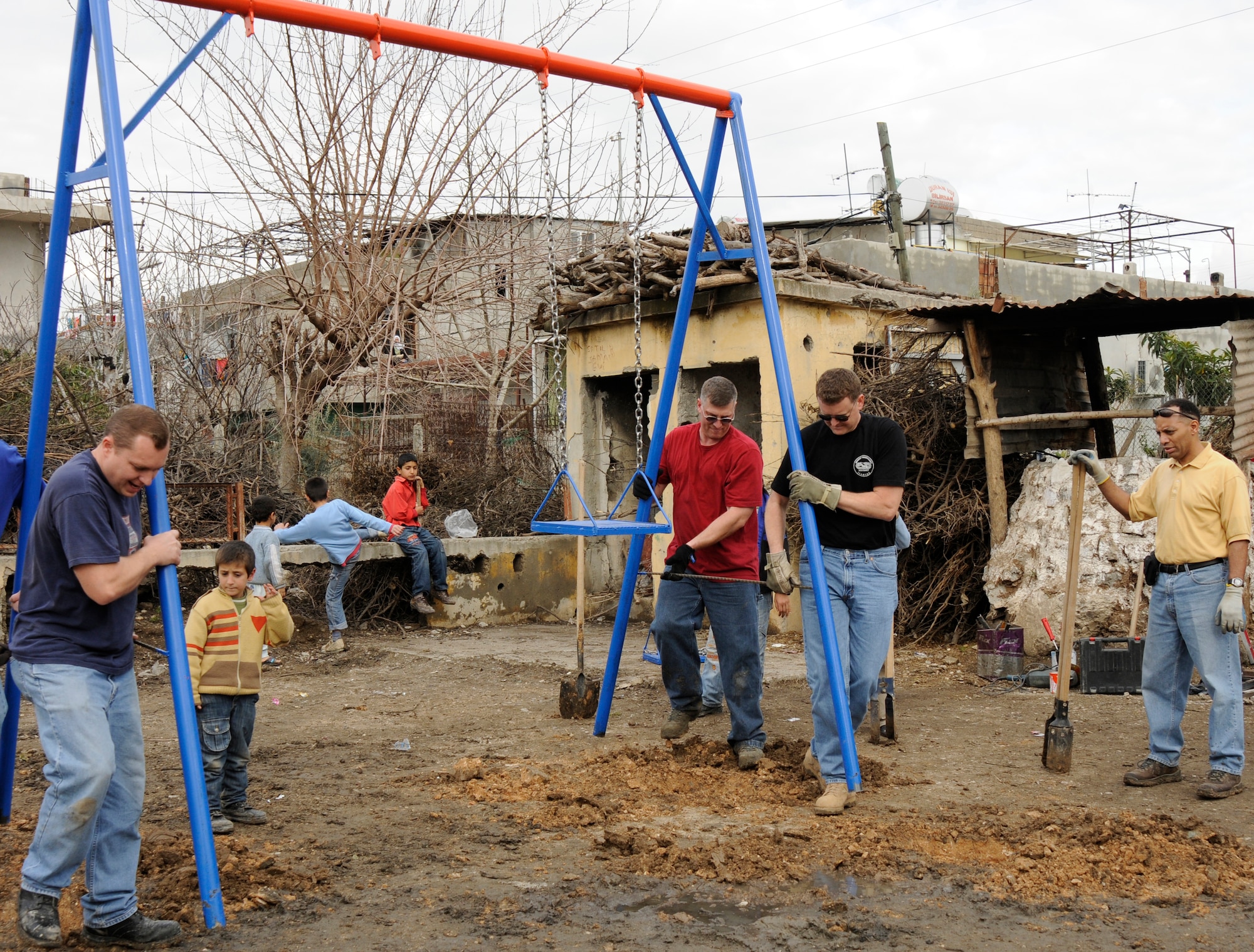 Members from the 385th Air Expeditionary Group place a swing set into the ground at a park being built for local Turkish children Wednesday, Feb. 25, 2009, in Adana, Turkey. The Sioux City, Iowa-based Air National Guardsmen prided themselves on their history of helping those at every location where they serve. (U.S. Air Force photo/Airman 1st Class Amber Russell)