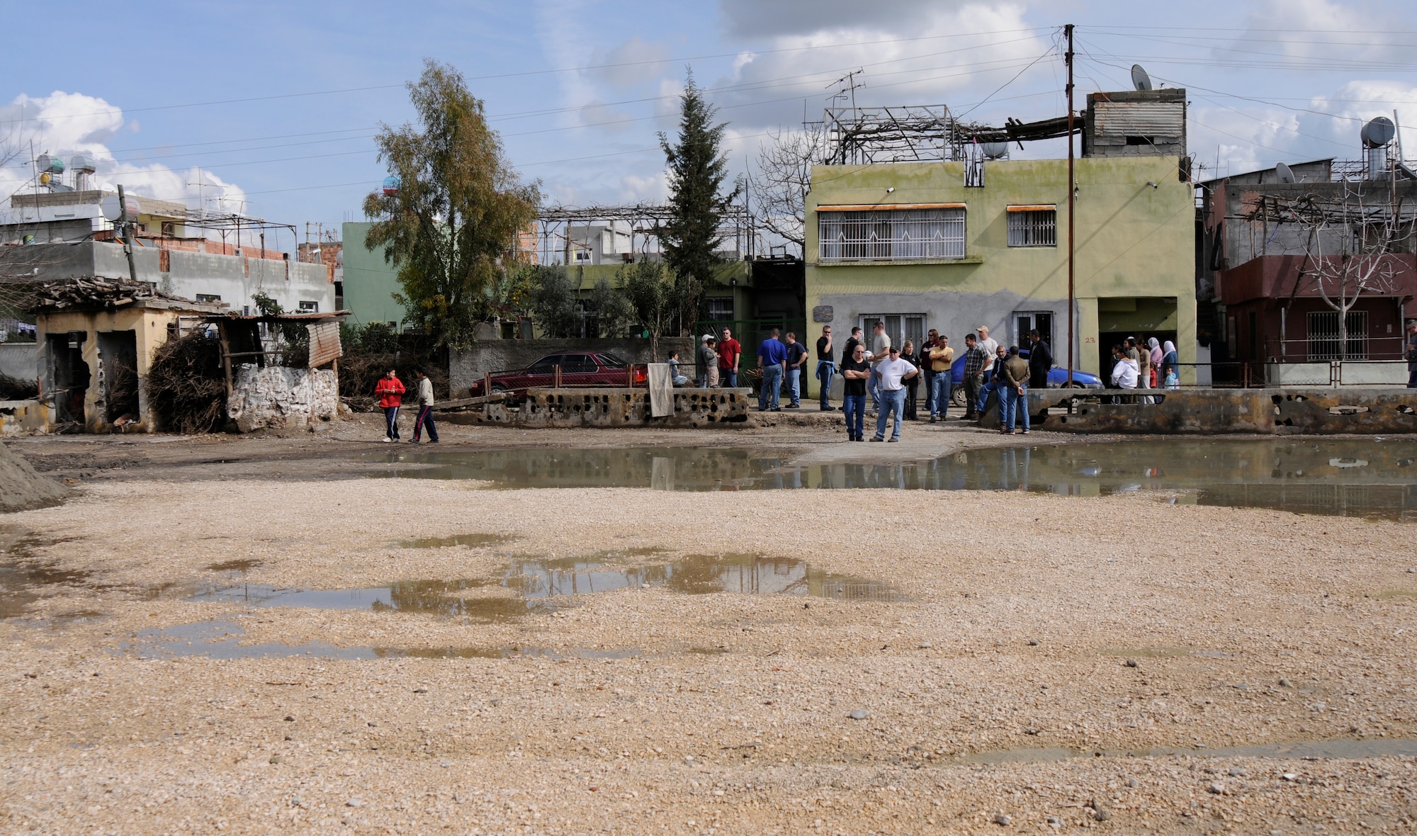 Members from the 385th Air Expeditionary Group assess an empty lot for water removal and placement of donated playground equipment for local Turkish children Wednesday, Feb. 25, 2009 in Adana, Turkey. The members are originally assigned to the 185th Air Refueling Wing, which is an Air National Guard unit based in Sioux City, Iowa. They are deployed to Incirlik to support operations for Central Command (U.S. Air Force photo/Airman 1st Class Amber Russell)