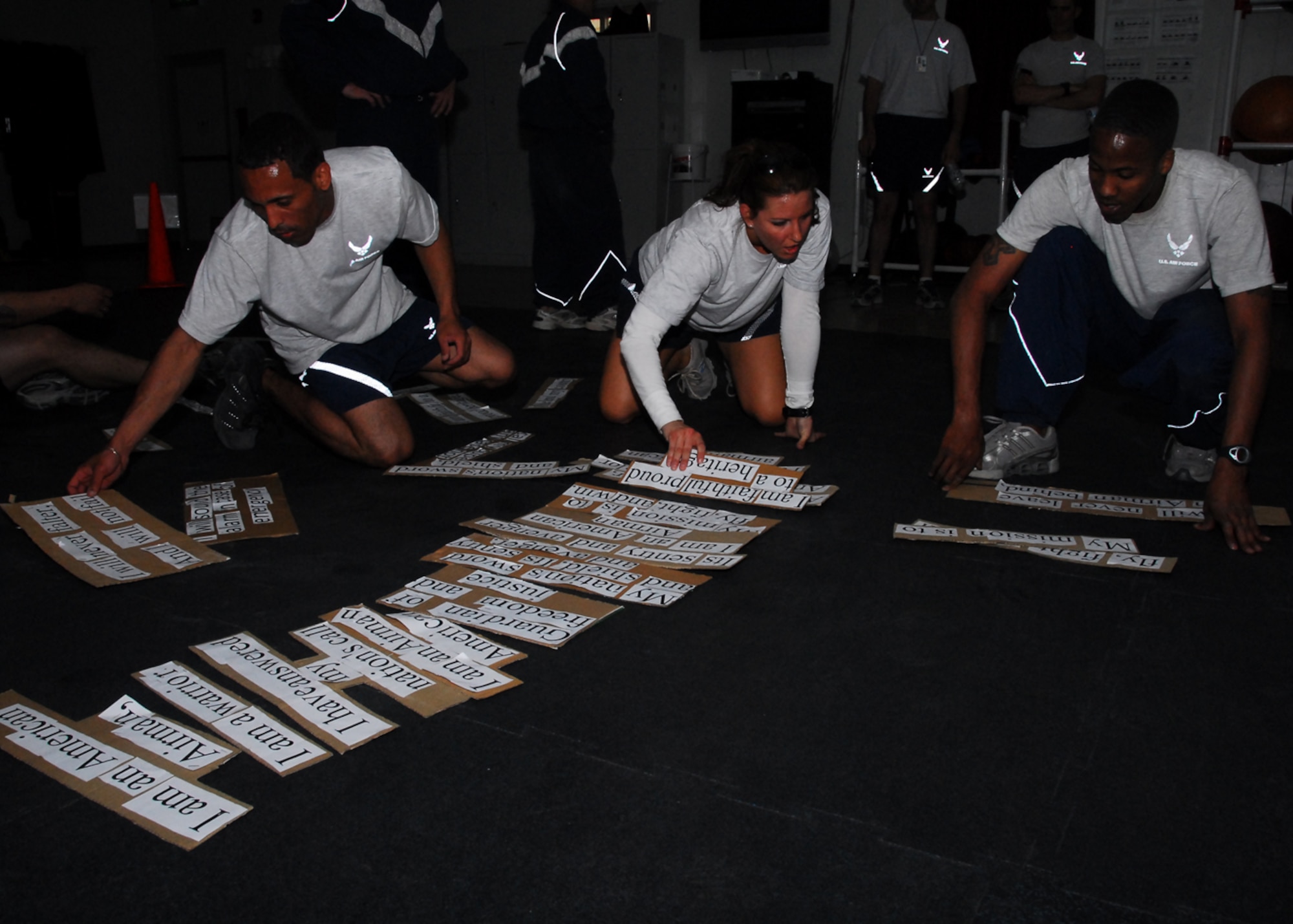 SOUTHWEST ASIA -- Airmen from the 386th Expeditionary Security Forces Squadron race against time to get the Airman's Creed in the correct order during the Fire Team Challenge at an air base in Southwest Asia, March 22. The challenge required the Airmen to rely on each other to complete each task to include self-aid and buddy care, M-4 assembly, litter carry, push-ups, sit-ups and pull-ups. (U.S. Air Force photo/ Senior Airman Courtney Richardson)