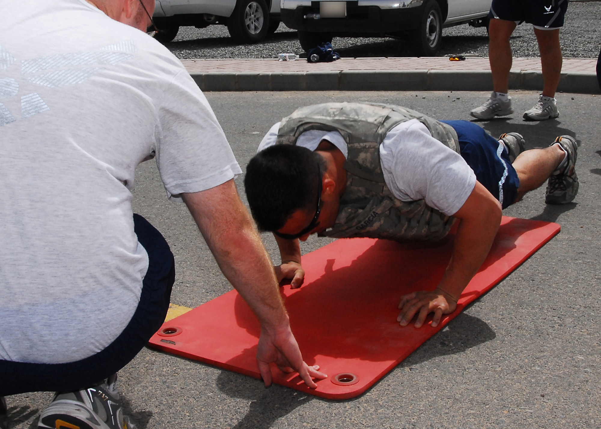 SOUTHWEST ASIA -- Senior Airman Juan Garcia, 386th Expeditionary Security Forces Squadron, pushes out 30 pushups during the Fire Team Challenge at an air base in Southwest Asia, March 22. The competition was a fitness based to help build teamwork and morale. Airman Garcia is currently deployed from McConnell Air Force Base, Kan. and is originally from San Bernardino, Calif. (U.S. Air Force photo/ Senior Airman Courtney Richardson)