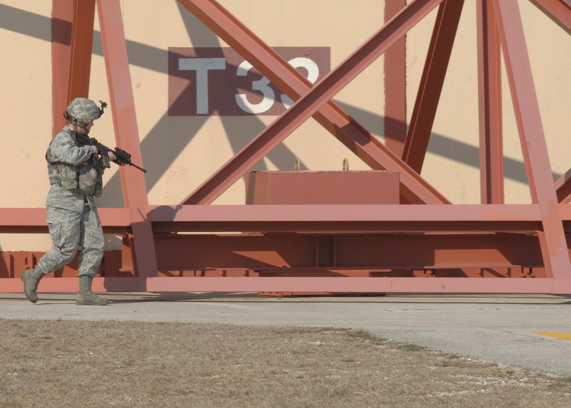 Airman 1st Class Jennifer Cavanaugh, 31st Security Forces Squadron, conducts a perimeter sweep of an aircraft shelter during a base exercise March 20.  The 31st Security Forces Squadron prepares 117 primary mobility personnel, maintains organic air base defense capabilities and provides staff assistance and security oversight to eight geographically separated locations within the Aviano community.  (U.S. Air Force photo/Airman 1st Class Tabitha M. Mans)
