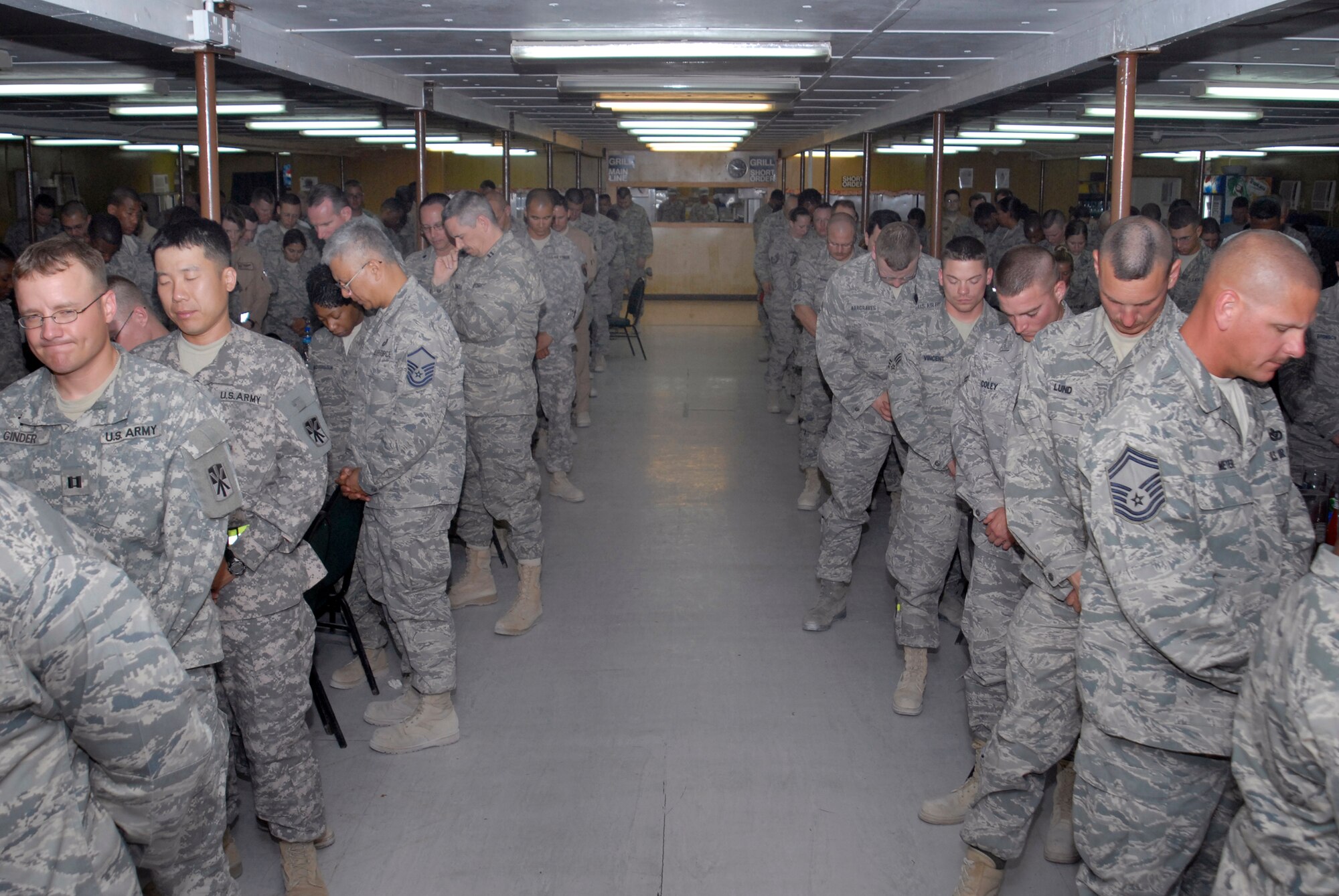 During the National Prayer Dinner personnel from all different services and faiths pray together, Mar. 20, 2009, at an undisclosed location in Southwest Asia.  Airmen, Soldiers, Sailors, and Marines all shared dinner together in honor of their faith and for their spiritual needs.  The servicemembers are deployed in support of Operations Iraqi and Enduring Freedom and Combined Joint Task Force - Horn of Africa.  (U.S. Air Force photo/Senior Airman Andrew Satran/released)