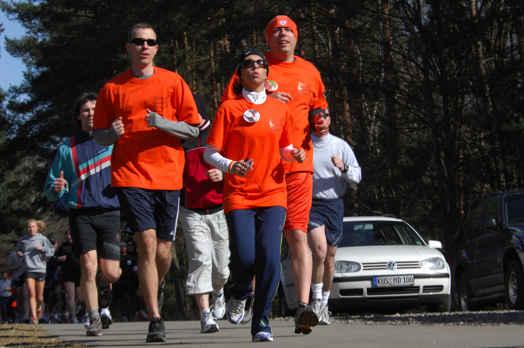 Master Sgt. Chris Sweet (right), runs with over 300 other Airmen and dependents during a 5K LOVESWEET memorial run in honor of his wife, Tech. Sgt. Jessica Sweet, March 18, 2009, Ramstein Air Base, Germany. Sergeant Jessica Sweet, 435th Communication Squadron supply, lost a hard fought battle to acute myelogeneous leukemia Feb. 12. (U.S. Air Force photo by Airman 1st Class Kenny Holston)