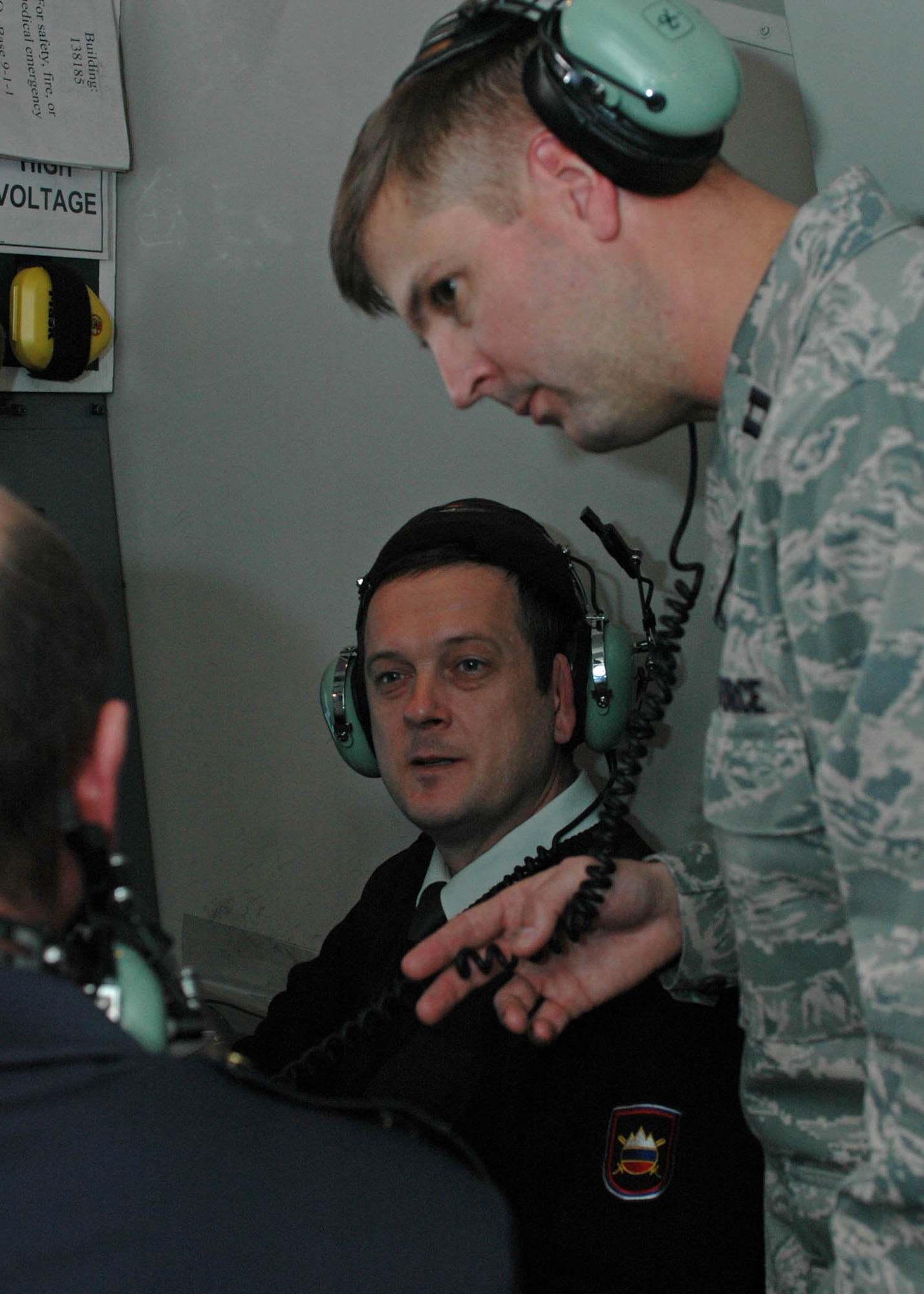 Capt. Michael Lake, 603rd Air Control Squadron director of operations, discusses equipment capabilities during a live mission here March 11 with Capt. Mihael Pavsic, center, and Maj. Andrej Jancevski and Lt. Peter Cuderman, not shown, from the 16th Air Surveillance Battalion command and reporting post.  The three Slovenian air force officers visited the 603rd ACS for a two-day joint training session March 10-11 as part of the United States Air Forces Europe 'Building Partnership Capacity' program.  (U.S. Air Force photo/Tech. Sgt. Michael O'Connor) 