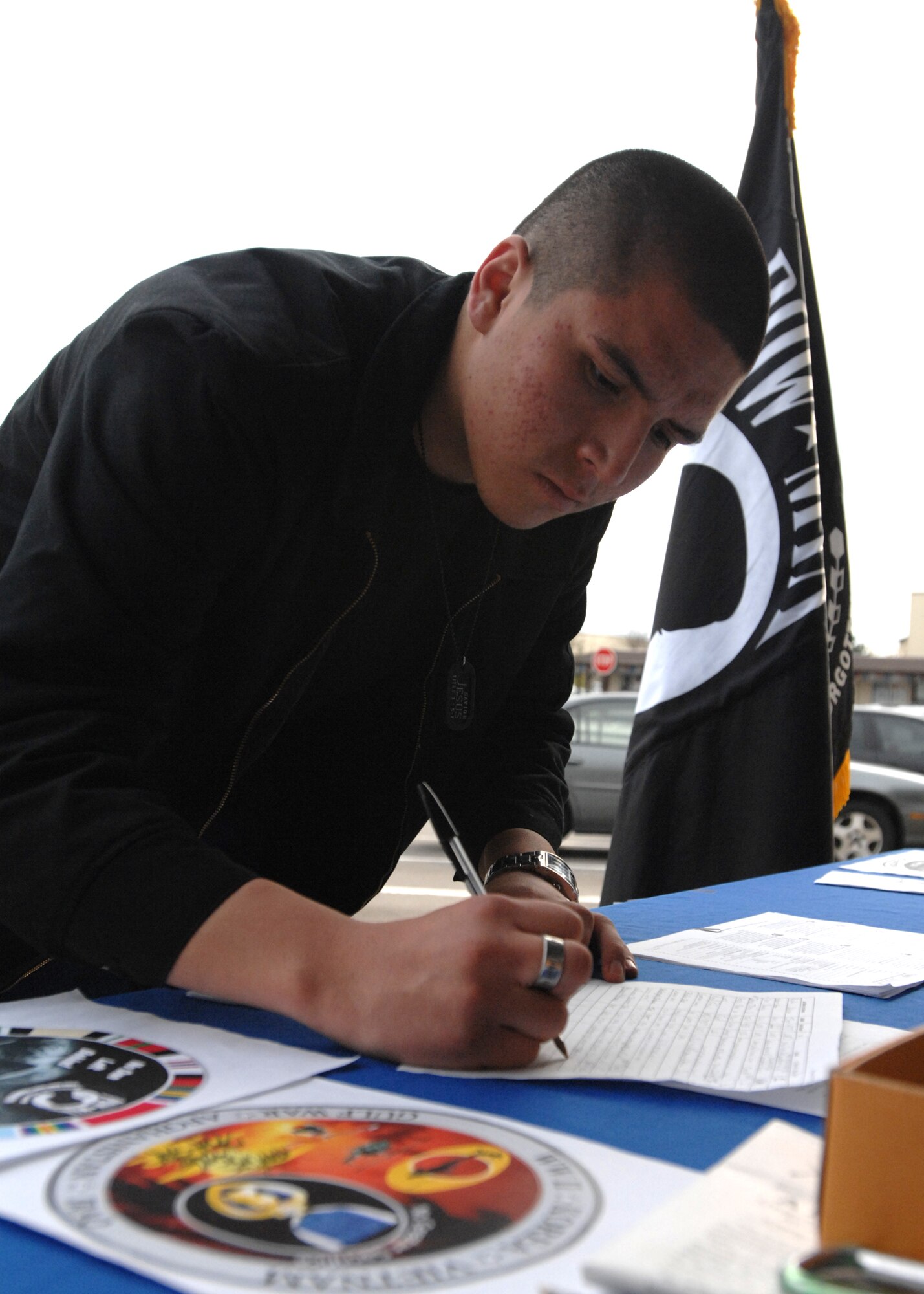 SPANGDAHLEM AIR BASE, Germany -- Airman 1st Class Anthony Alvarez, 52nd Civil Engineer Squadron, purchases a Prisoner of War coin March 13, 2009.  The Air Force Sergeants Association sponsored the fundraiser to raise money for POW awareness.  (U.S. Air Force photo by Senior Airman Jenifer H. Calhoun)