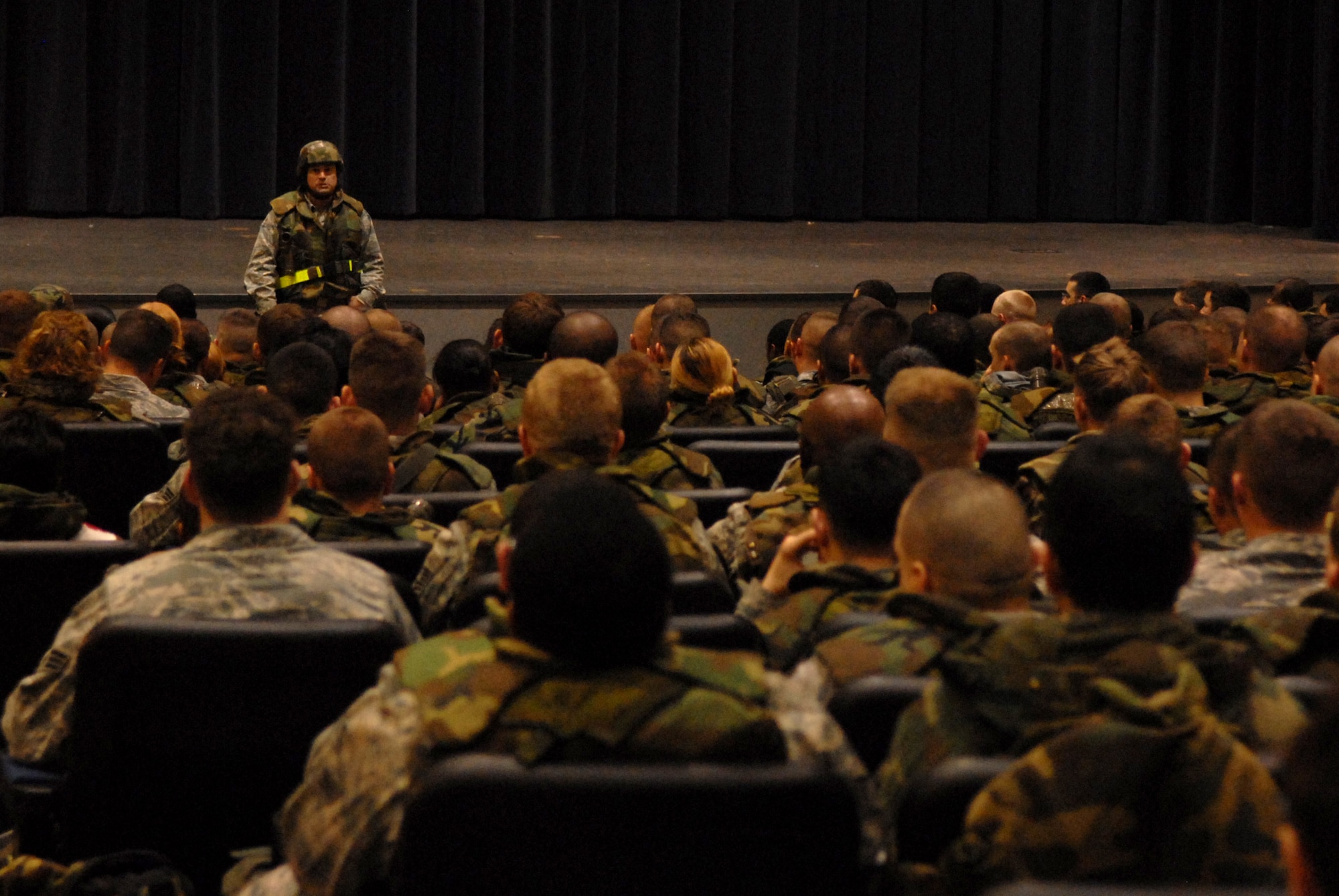 Colonel Robert Nuanes, 8th Mission Support Group commander, briefs more than 200 Airmen during Wolf War day at Kunsan Air Base, Republic of Korea, March 23, 2009. The 8th Fighter Wing Airmen participate in Wolf War day practicing their war time capabilities in preparation for the Peninsula Wide Operational Readiness Exercise and Inspection.(US Air Force photo By: Senior Airman Angela Ruiz) 