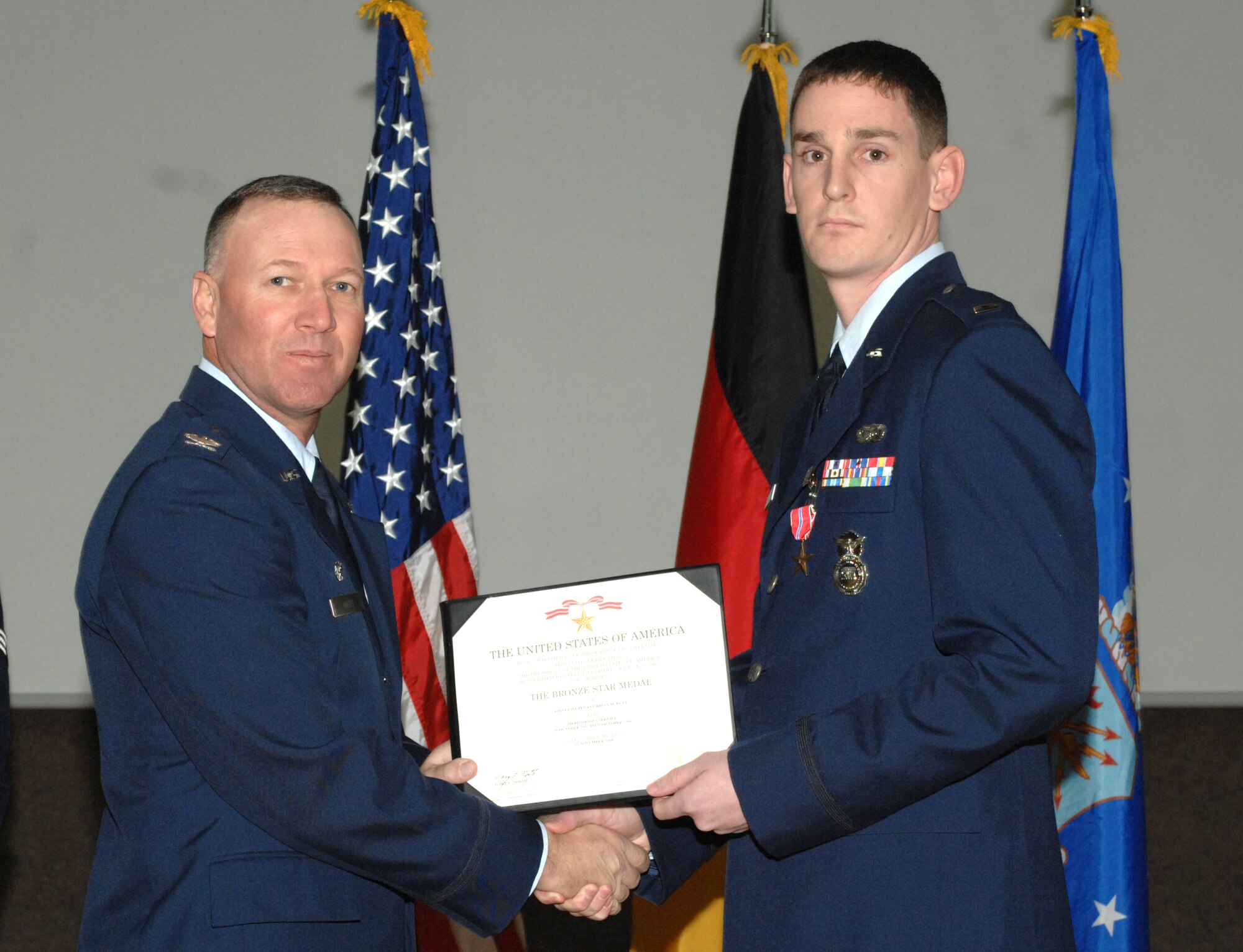SPANGDHALEM AIR BASE, Germany -- 1st Lt. Brian Rutt, 52nd Security Forces Squadron, is congratulated by Col. Lee Wight, 52nd Fighter Wing commander, for earning a Bronze Star Medal during his deployment with the 732nd Expeditionary Security Forces Squadron Feb. 19, 2009. (U.S. Air Force photo by Senior Airman Jenifer H. Calhoun)