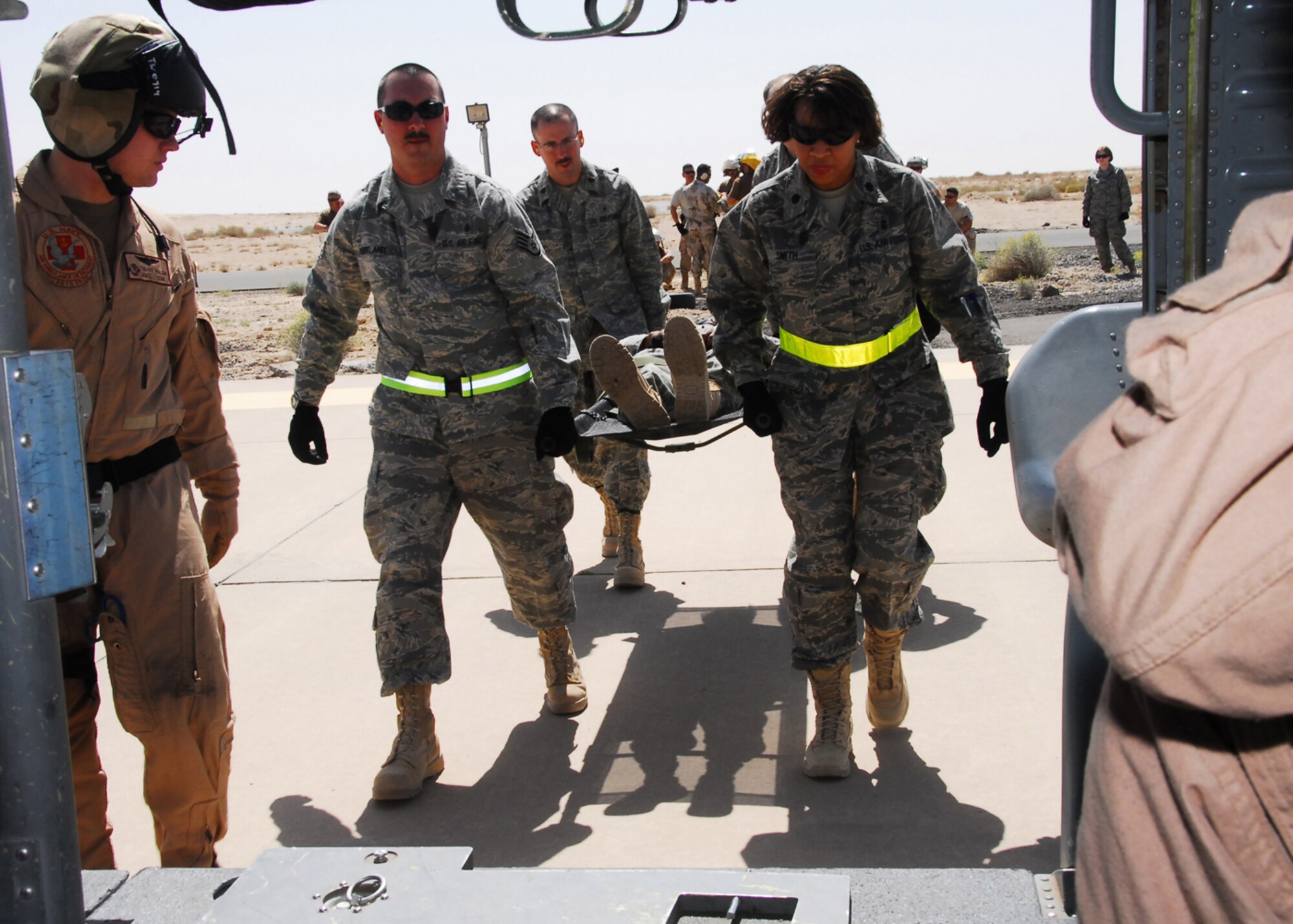 SOUTHWEST ASIA -- Airmen from the 386th Expeditionary Medical Group prepare to load a simulated patient onto a Navy  helicopter from the 2515th Naval Air Ambulance  during Litter Management System Training at an air base in Southwest Asia, March 20. The training allows medical personnel from the 386th EMDG to receive some refresher training about body mechanics, safety and loading of a litter patient. (U.S. Air Force photo/ Senior Airman Courtney Richardson)